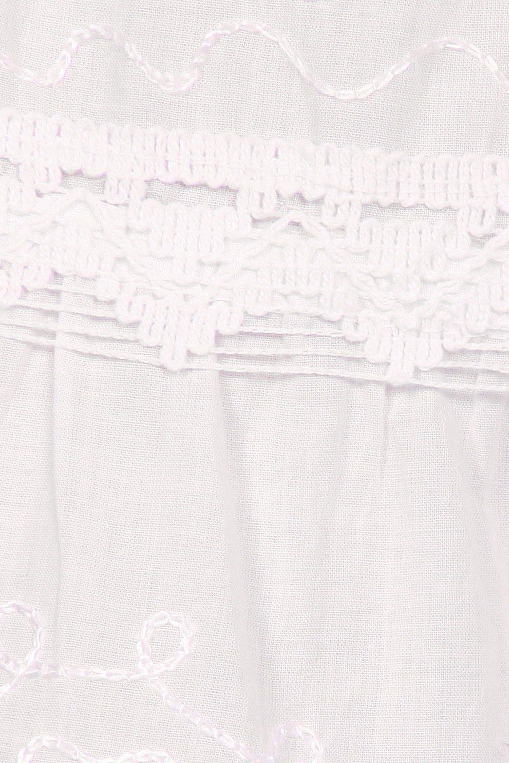 White dress with floral embroidery on a white background