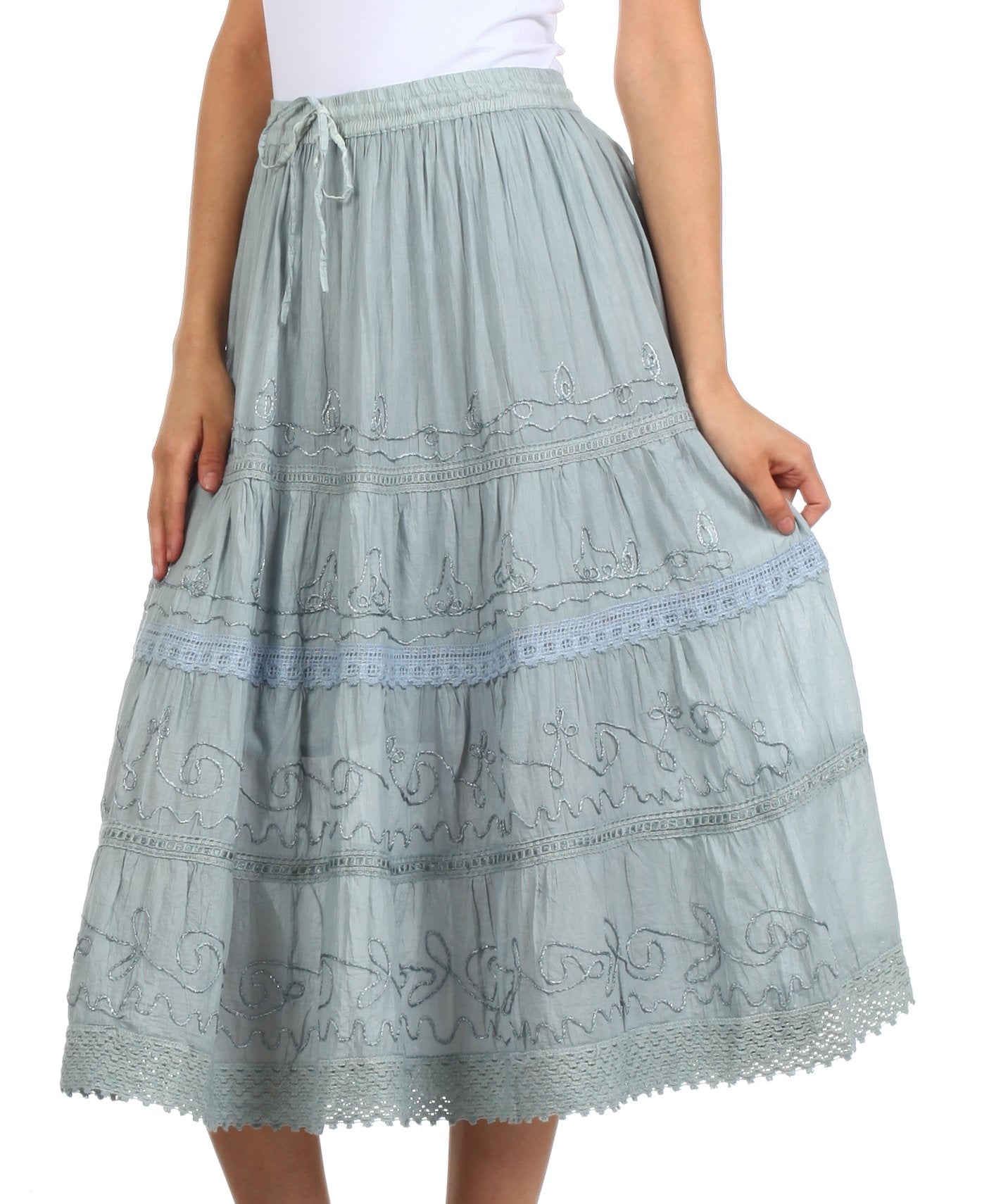 Light blue embroidered skirt worn by a person on a white background