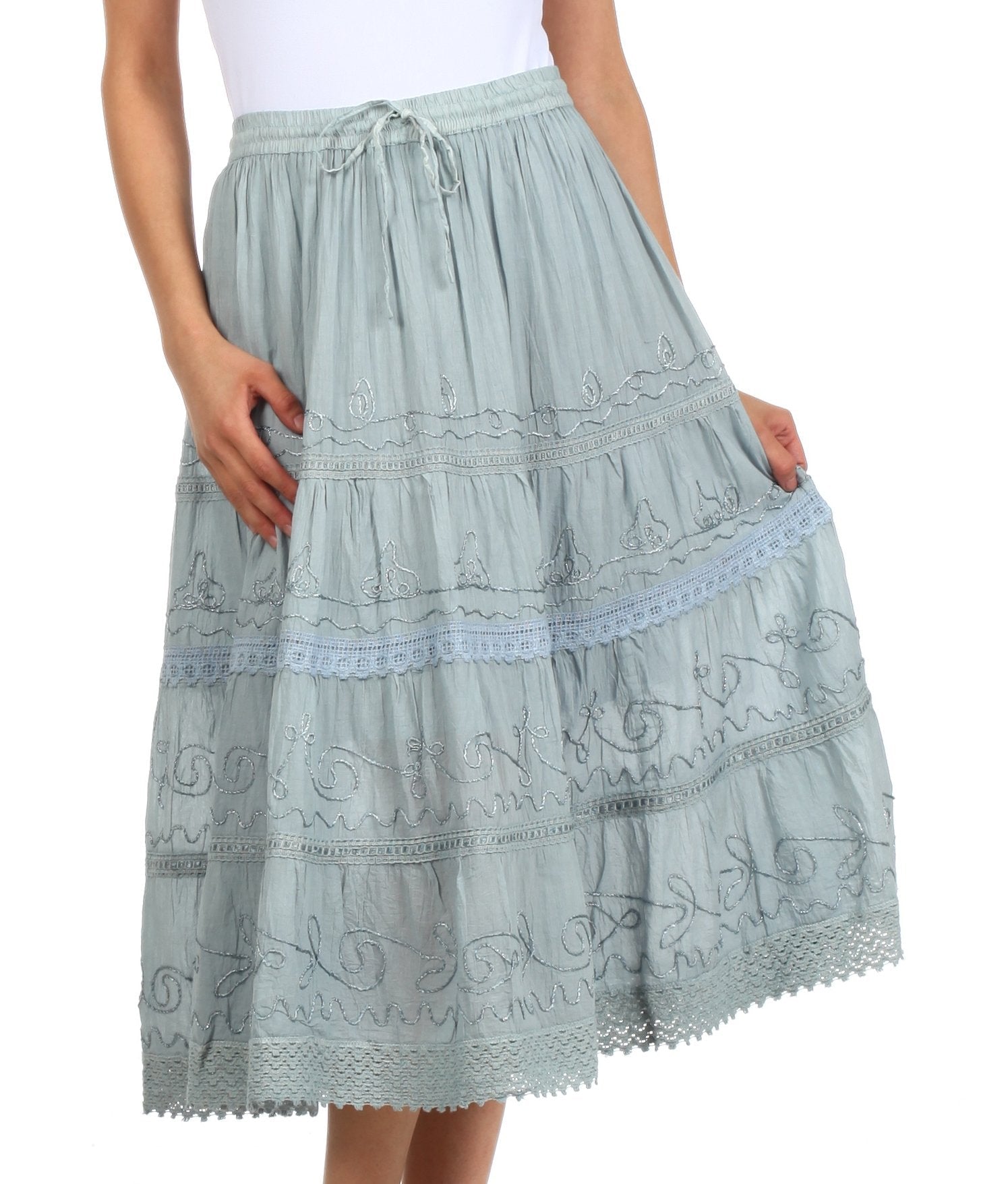 Light blue embroidered skirt worn by a person on a white background