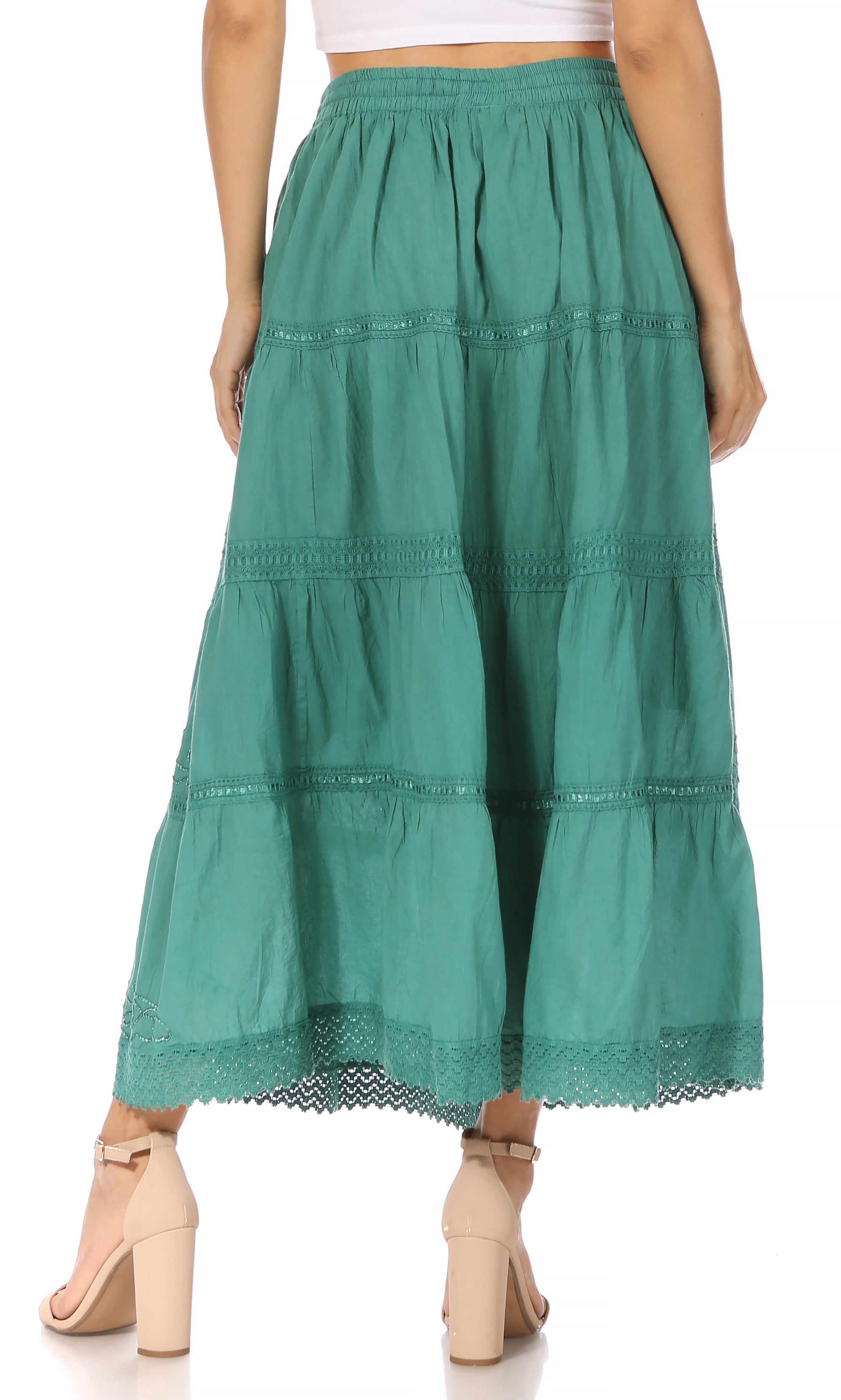 Green tiered skirt worn by a person on a white background