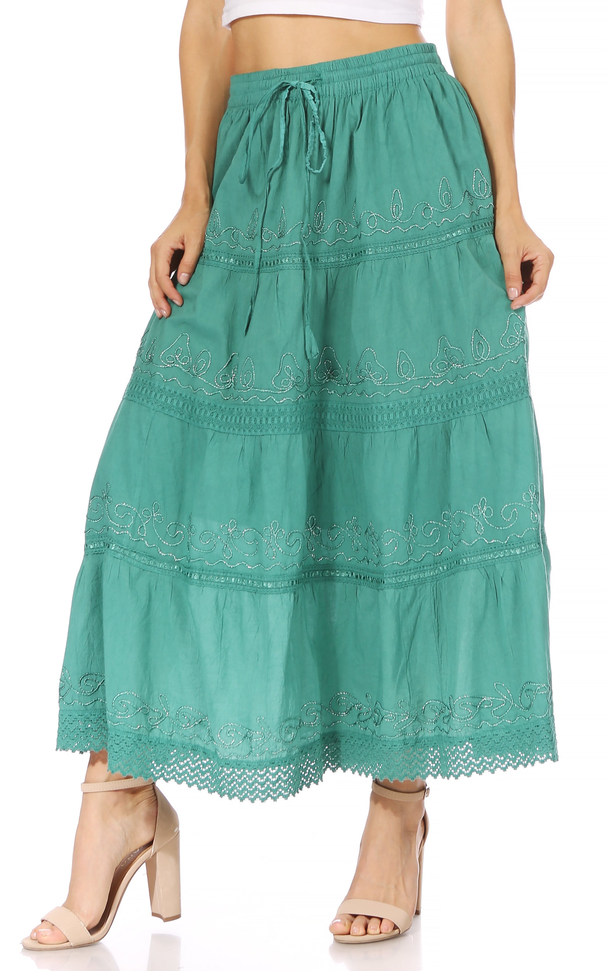 Green embroidered skirt worn by a person on a white background