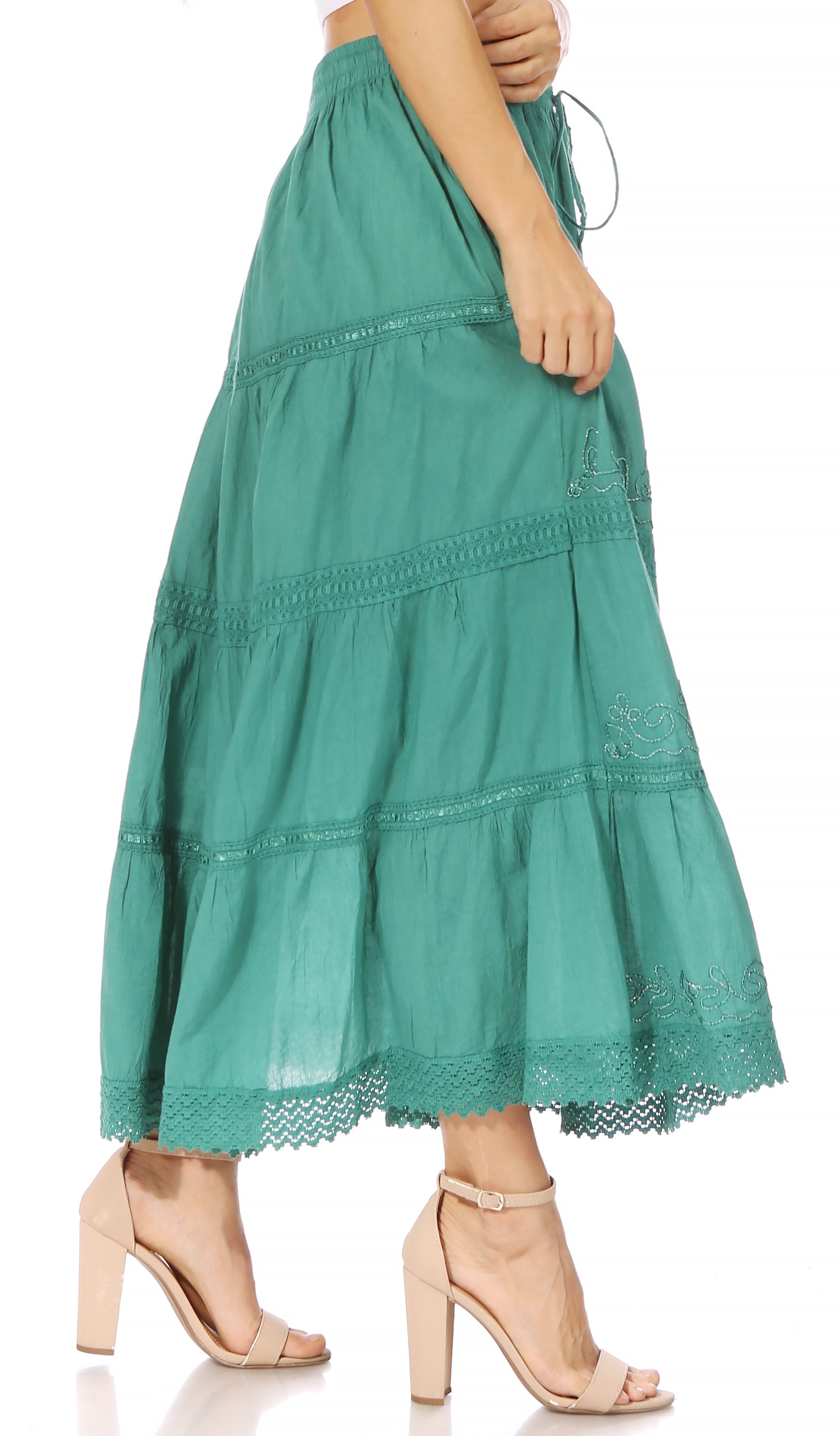 Green tiered skirt with lace details on a white background