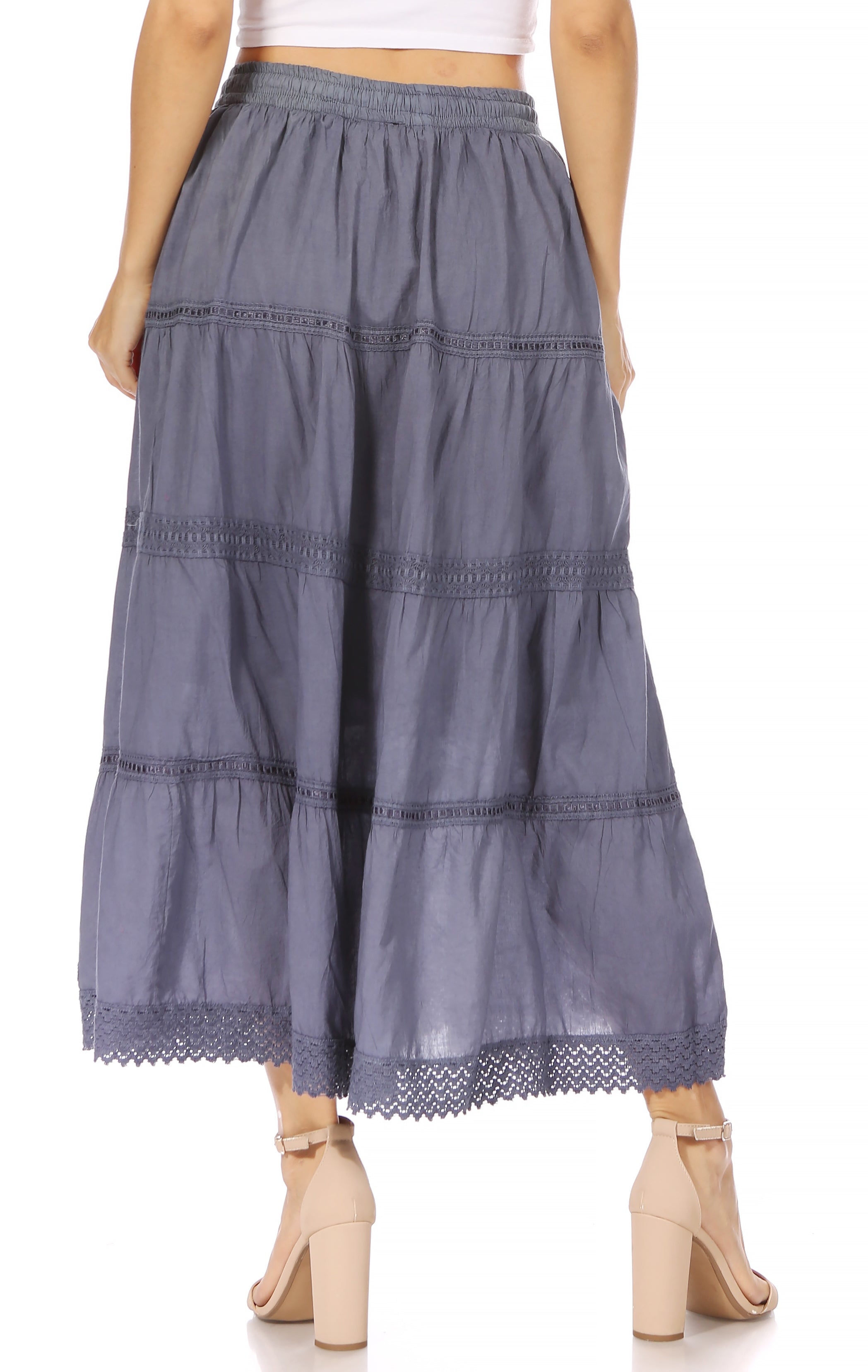 Long tiered skirt with lace trim worn by a person on a white background