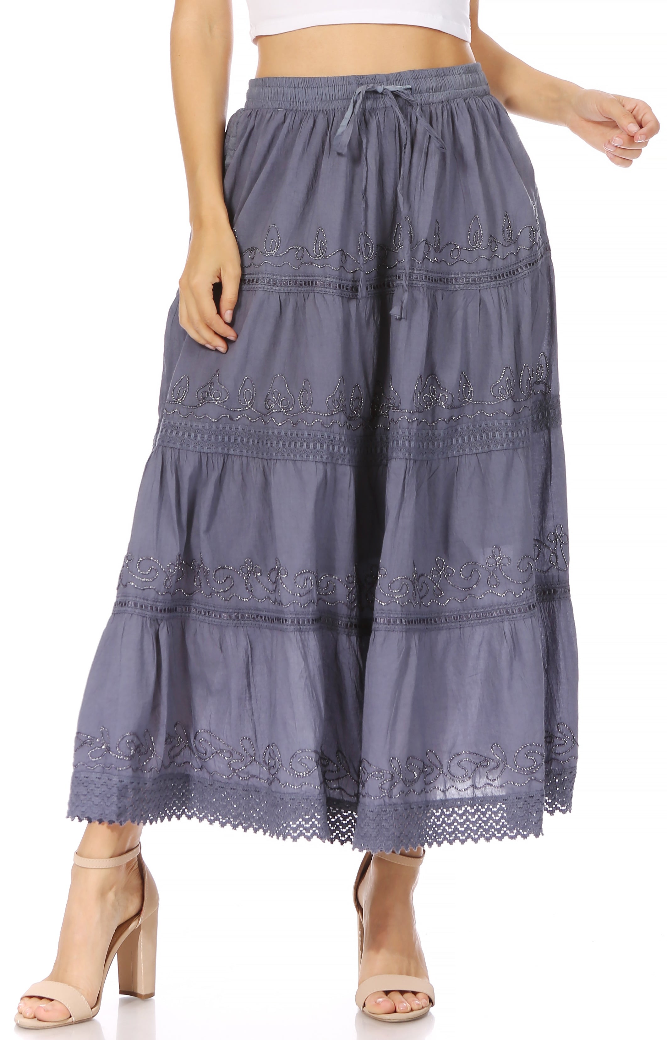 Long embroidered skirt worn by a person on a white background