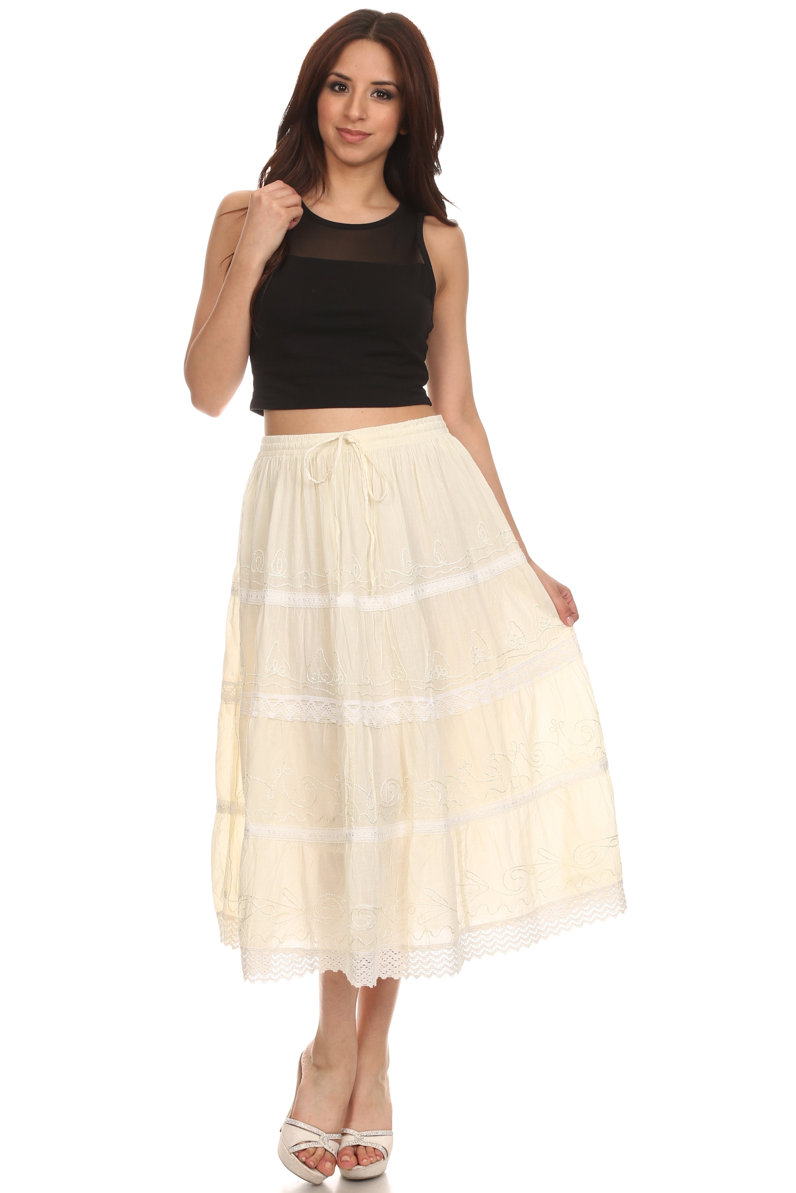 Woman wearing a black top and beige skirt on a white background