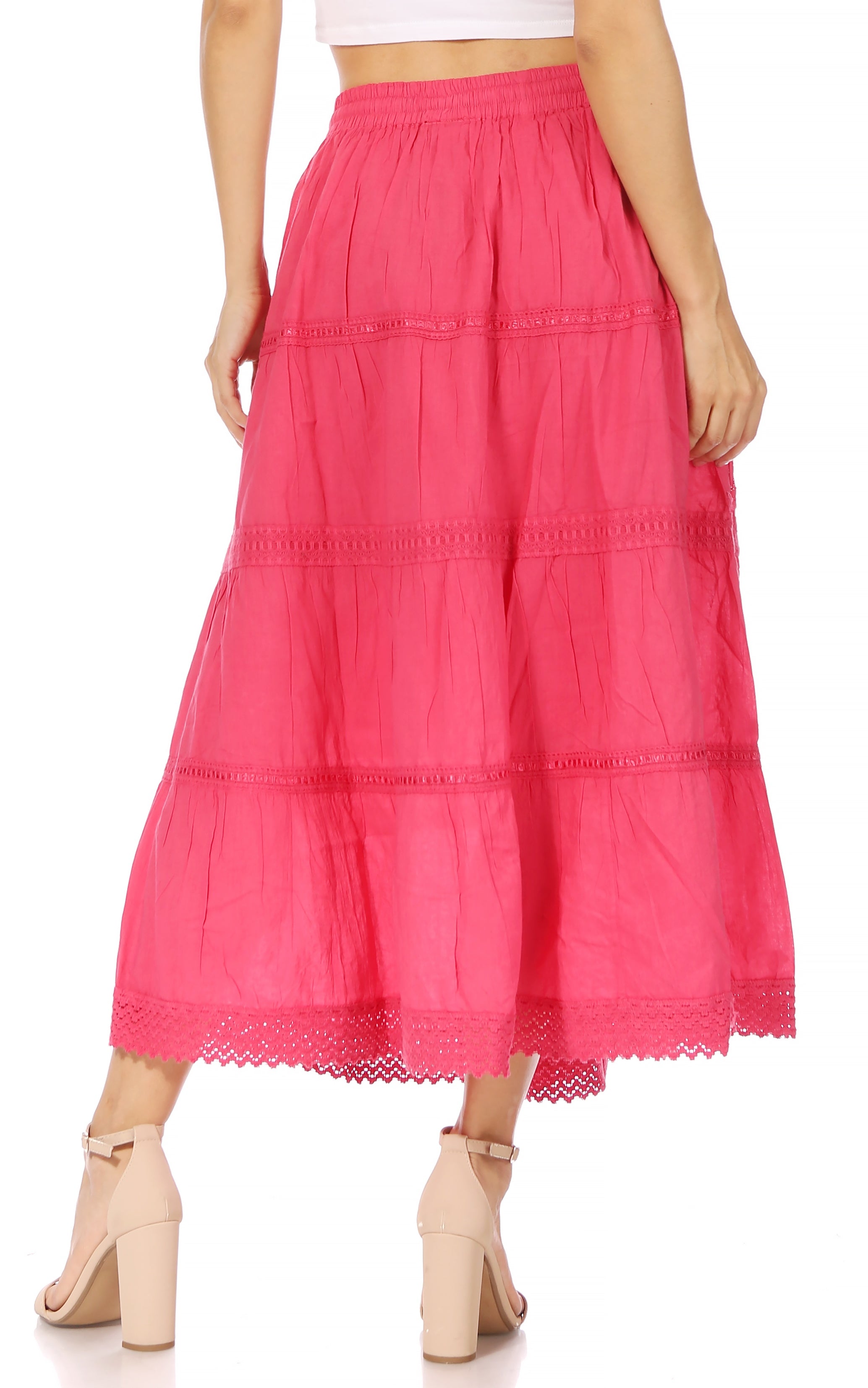 Pink tiered skirt worn by a person on a white background