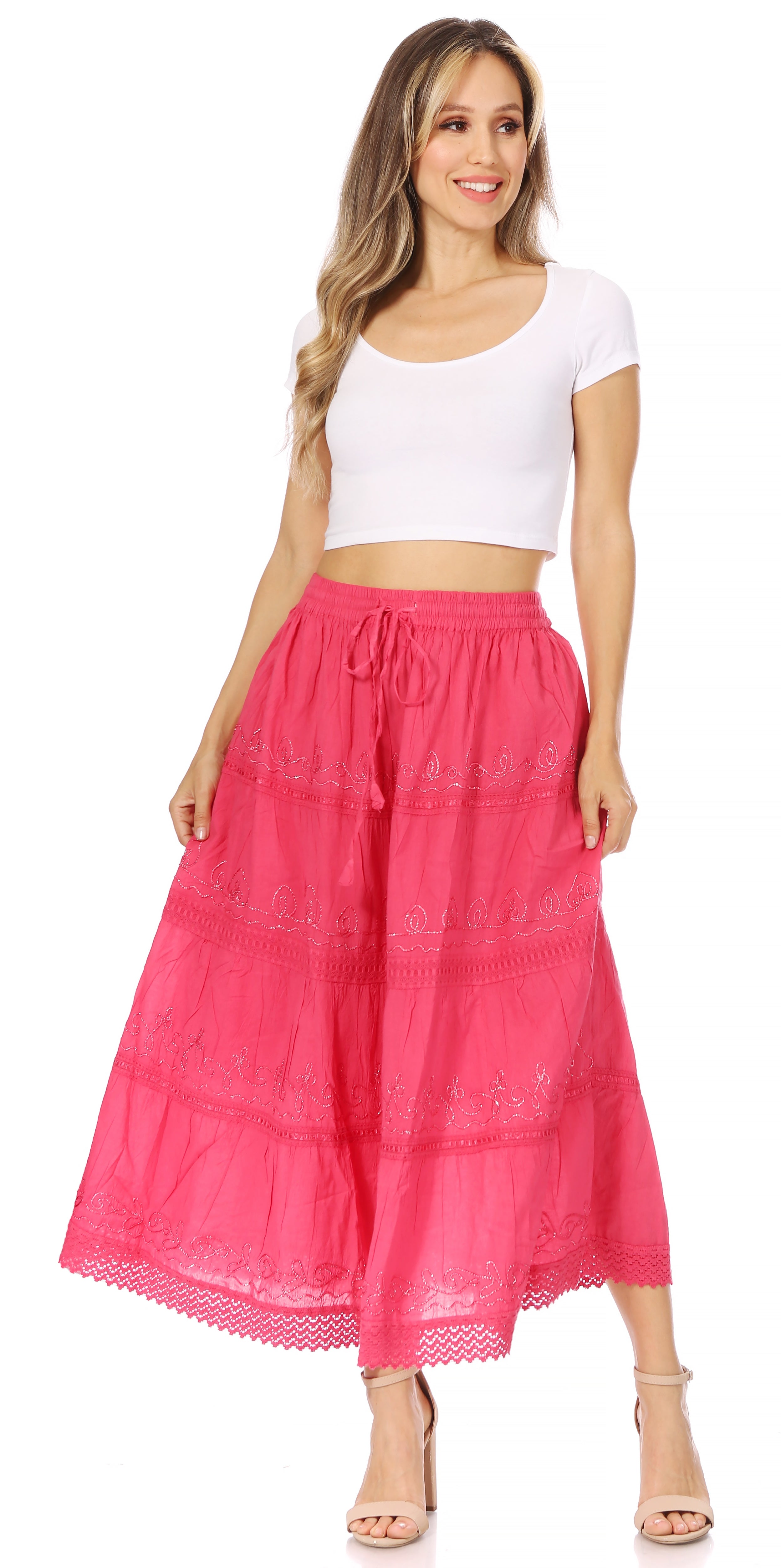 Woman wearing a white top and pink skirt on a white background