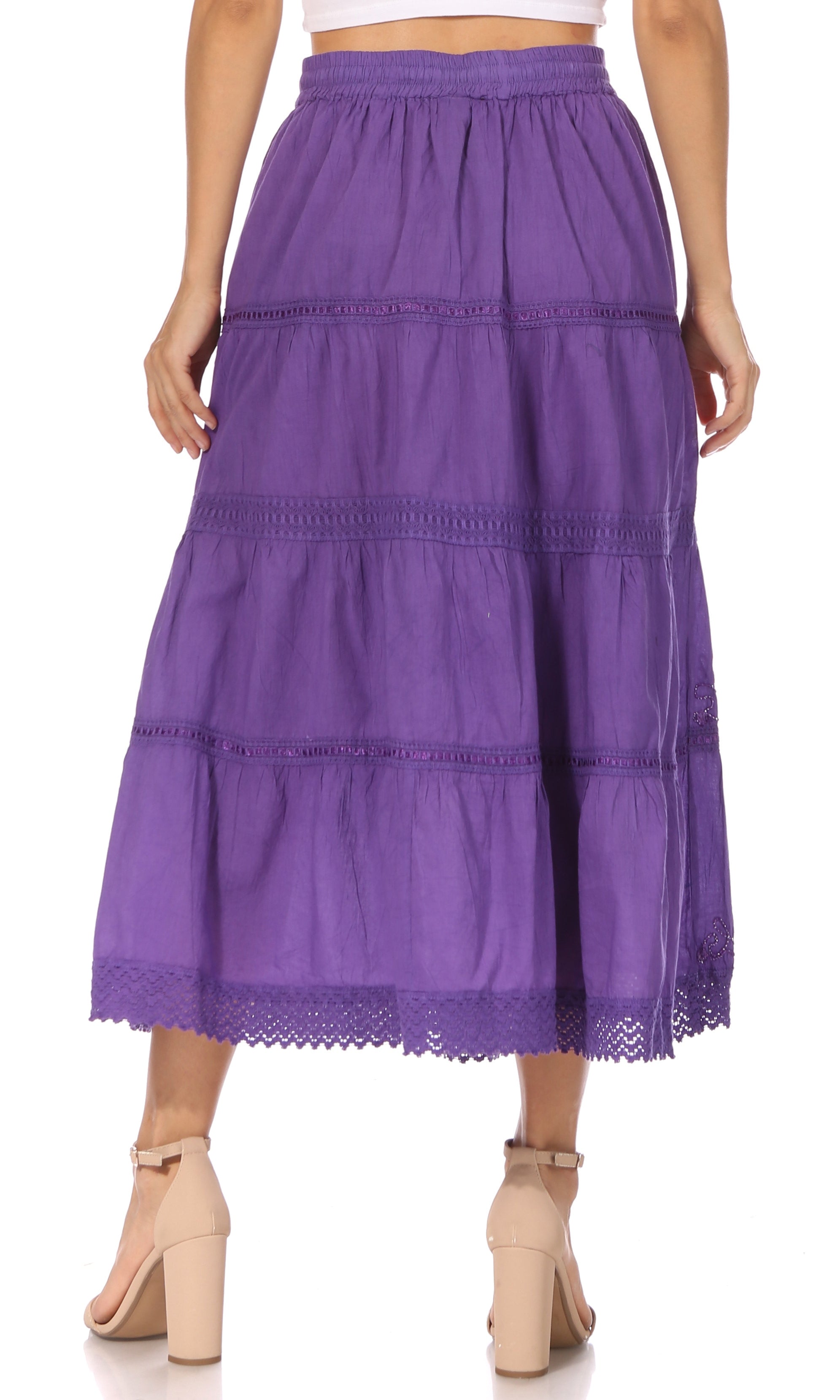 Purple tiered skirt worn by a person on a white background