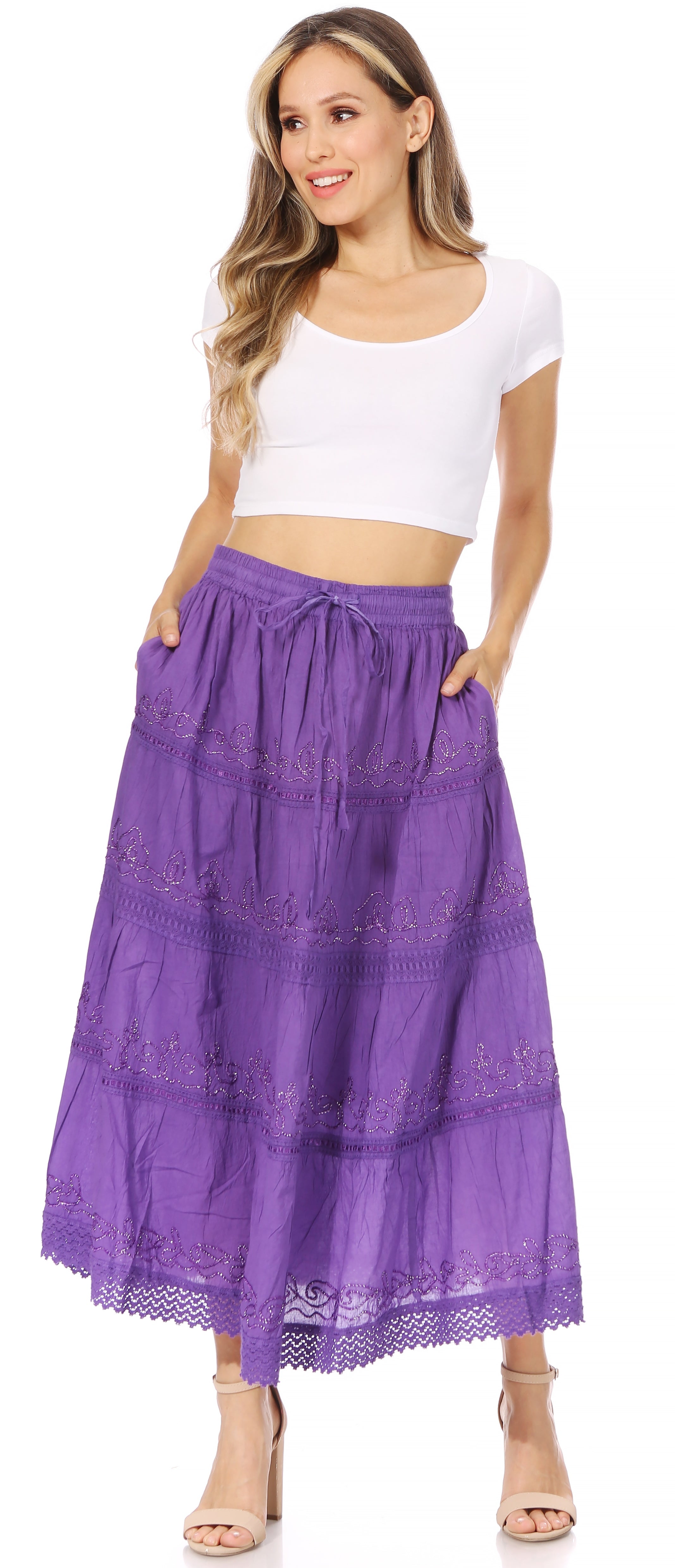 Woman wearing a purple skirt and white top on a white background