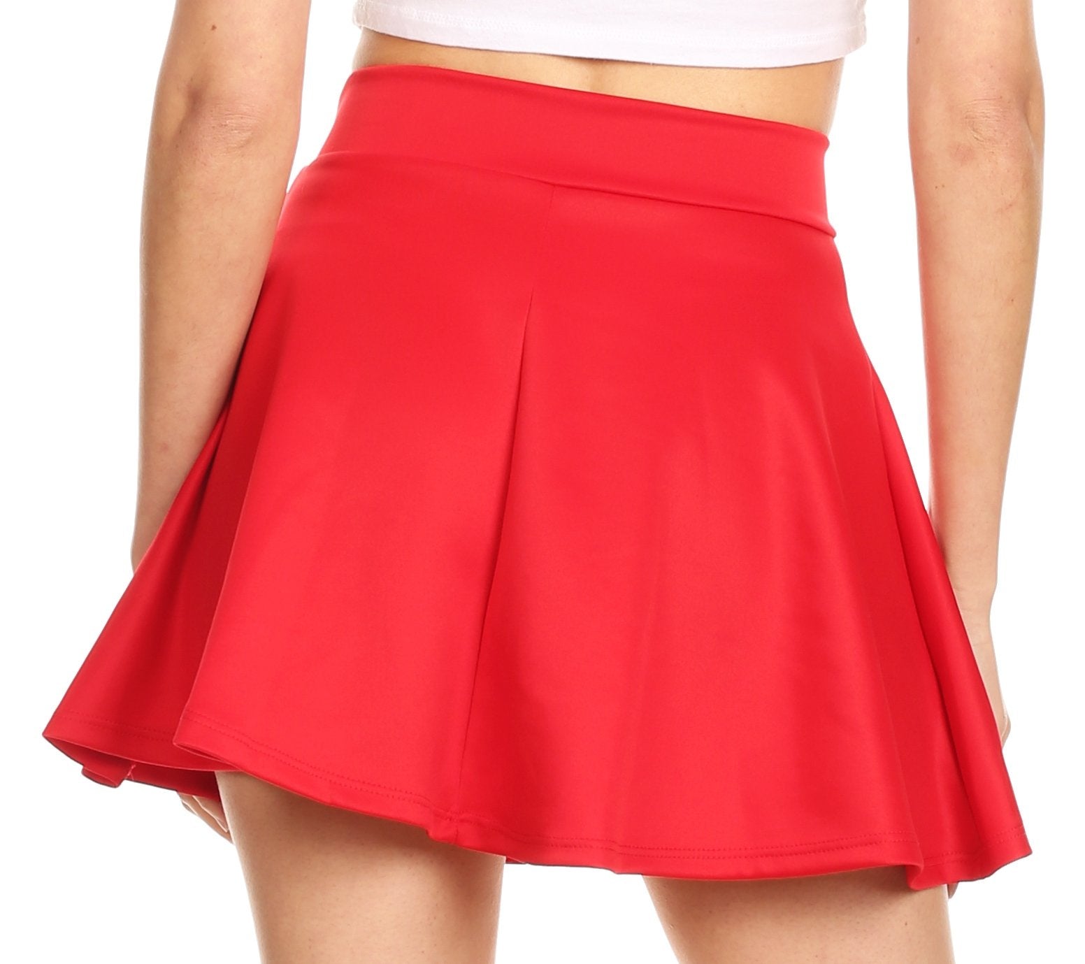 Red skirt worn by a person on a white background