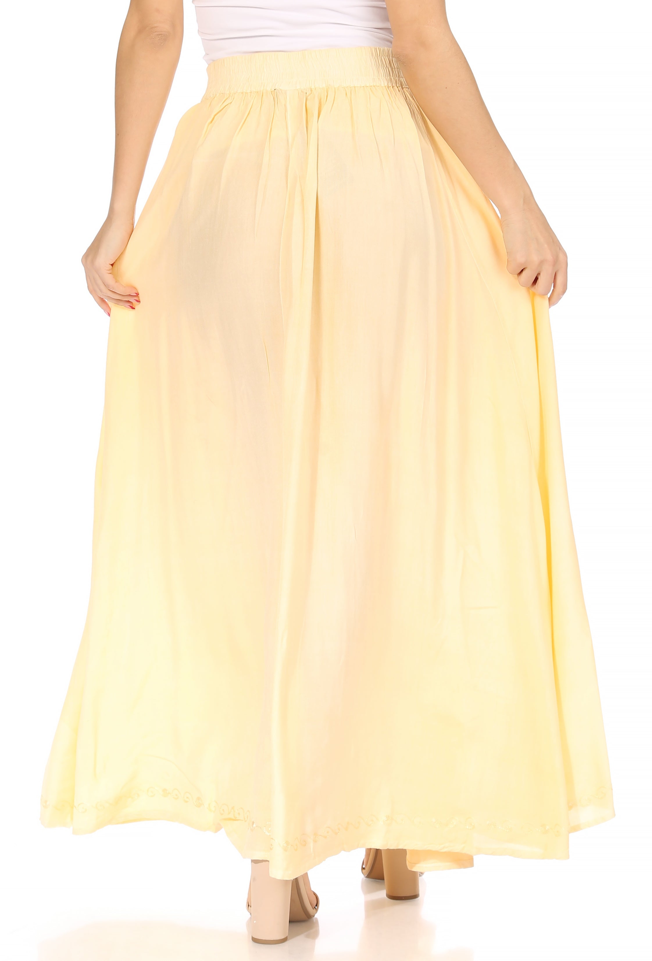 Yellow skirt worn by a person on a white background