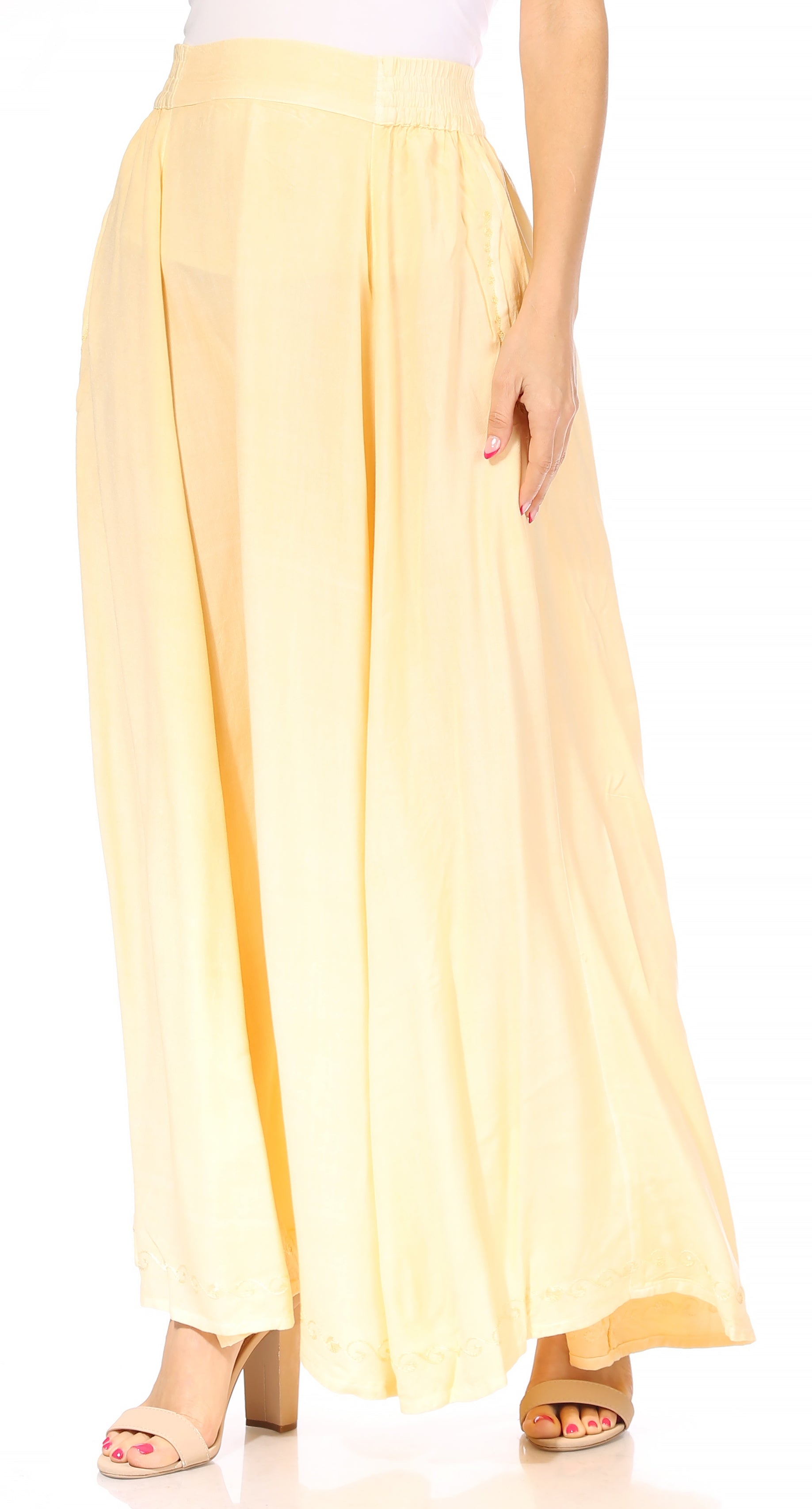 Light yellow wide-leg pants worn by a person on a white background
