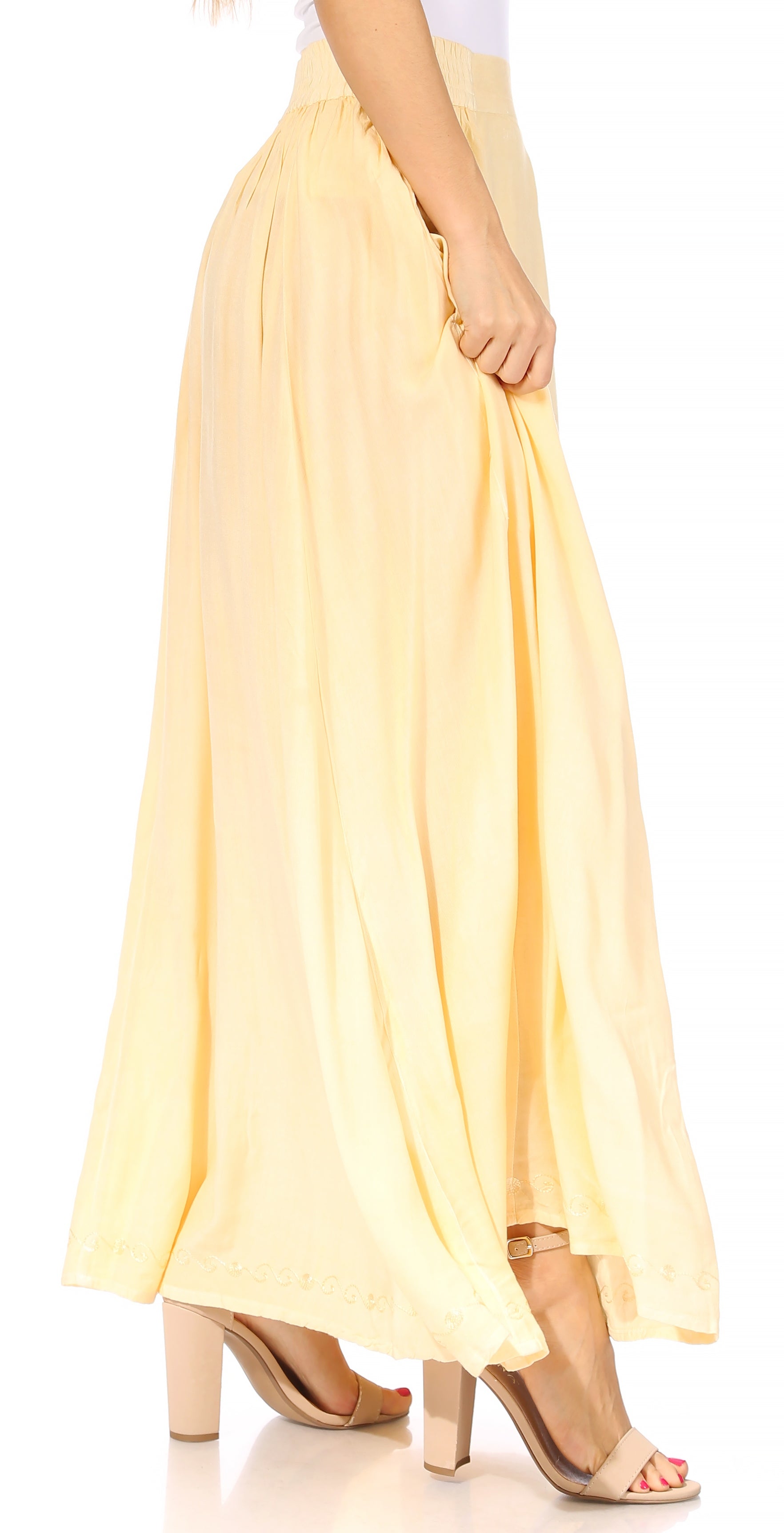 Yellow maxi skirt worn by a person on a white background