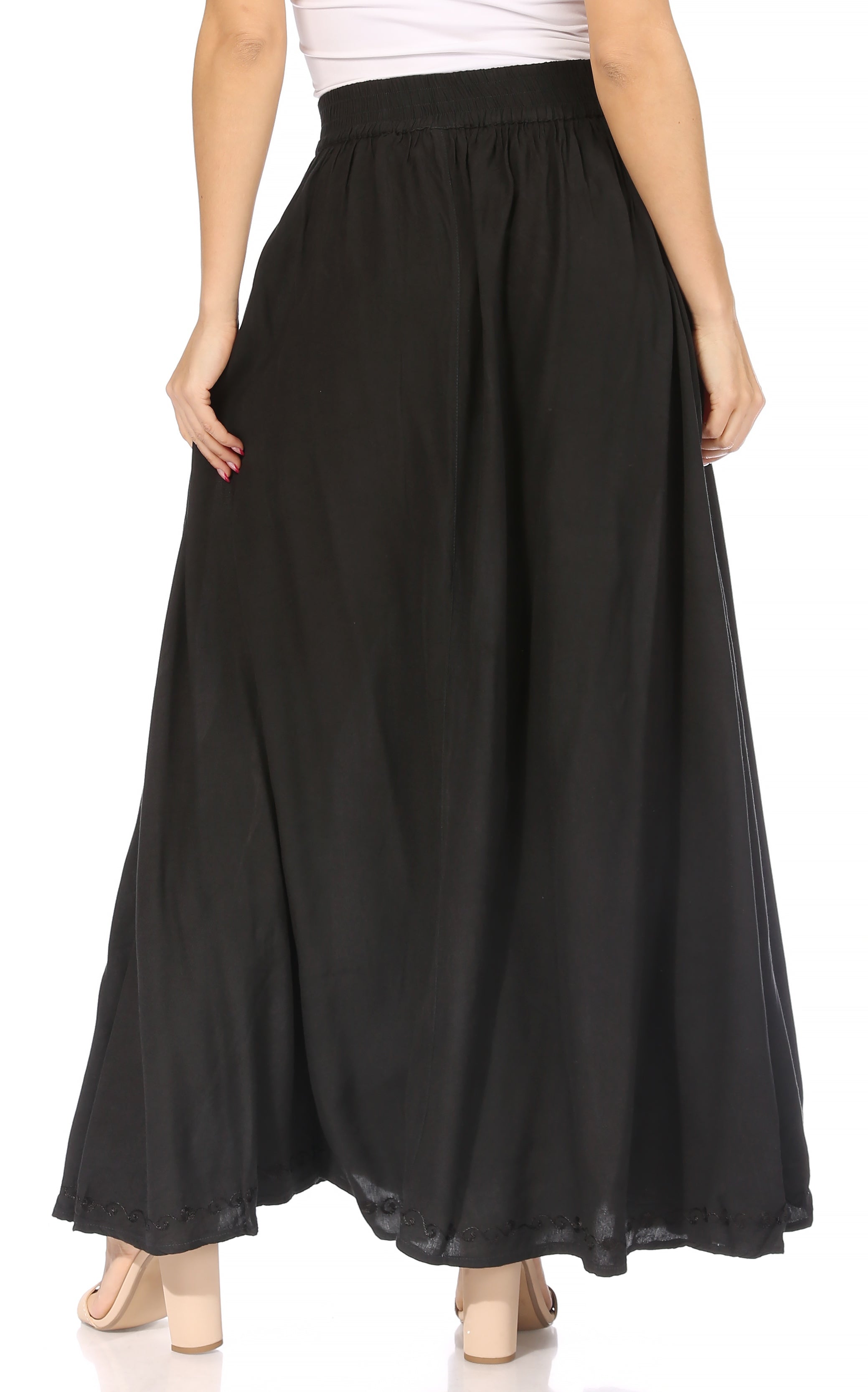 Black long skirt worn by a person on a white background