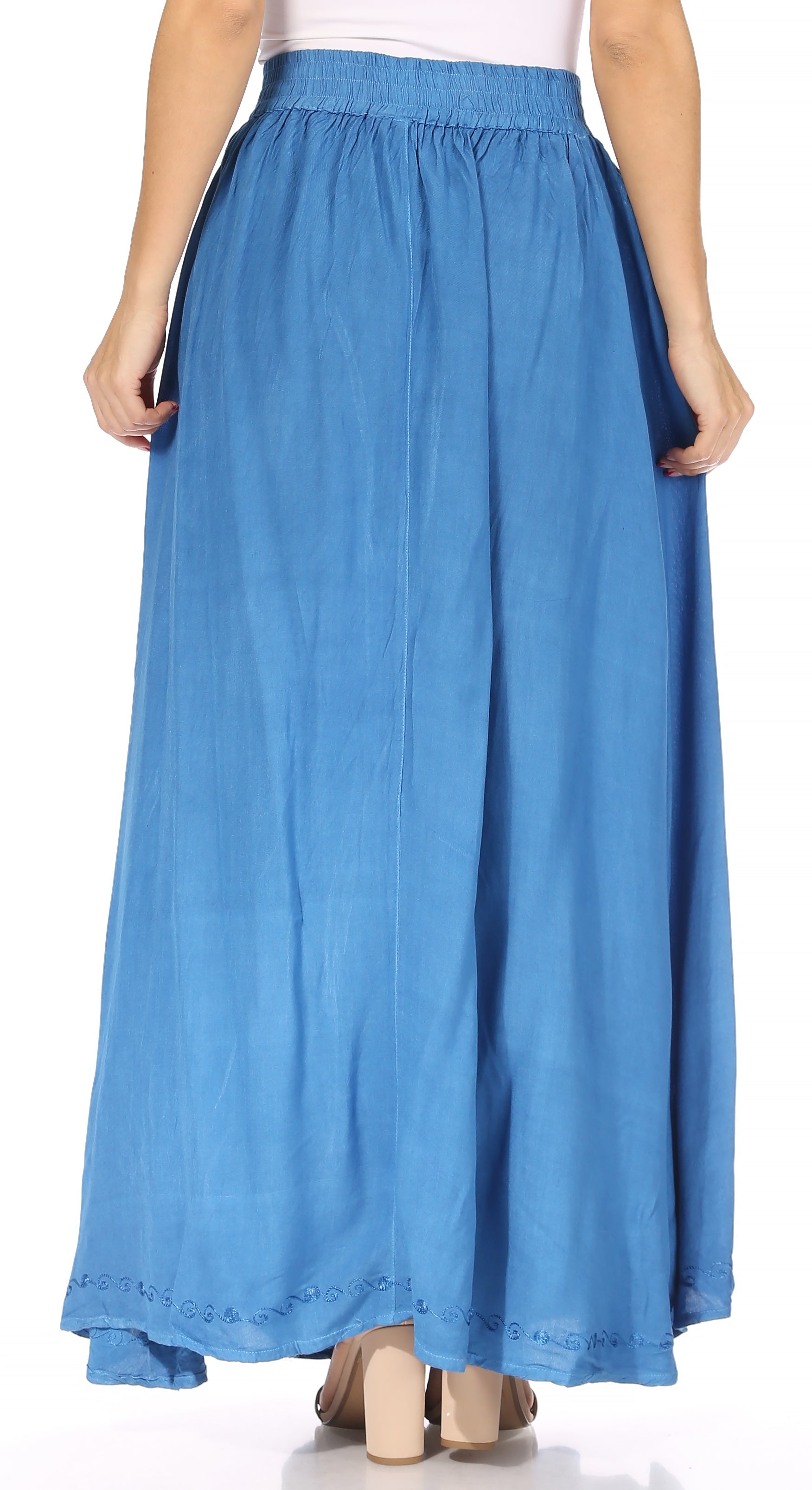 Blue denim skirt worn by a person on a white background