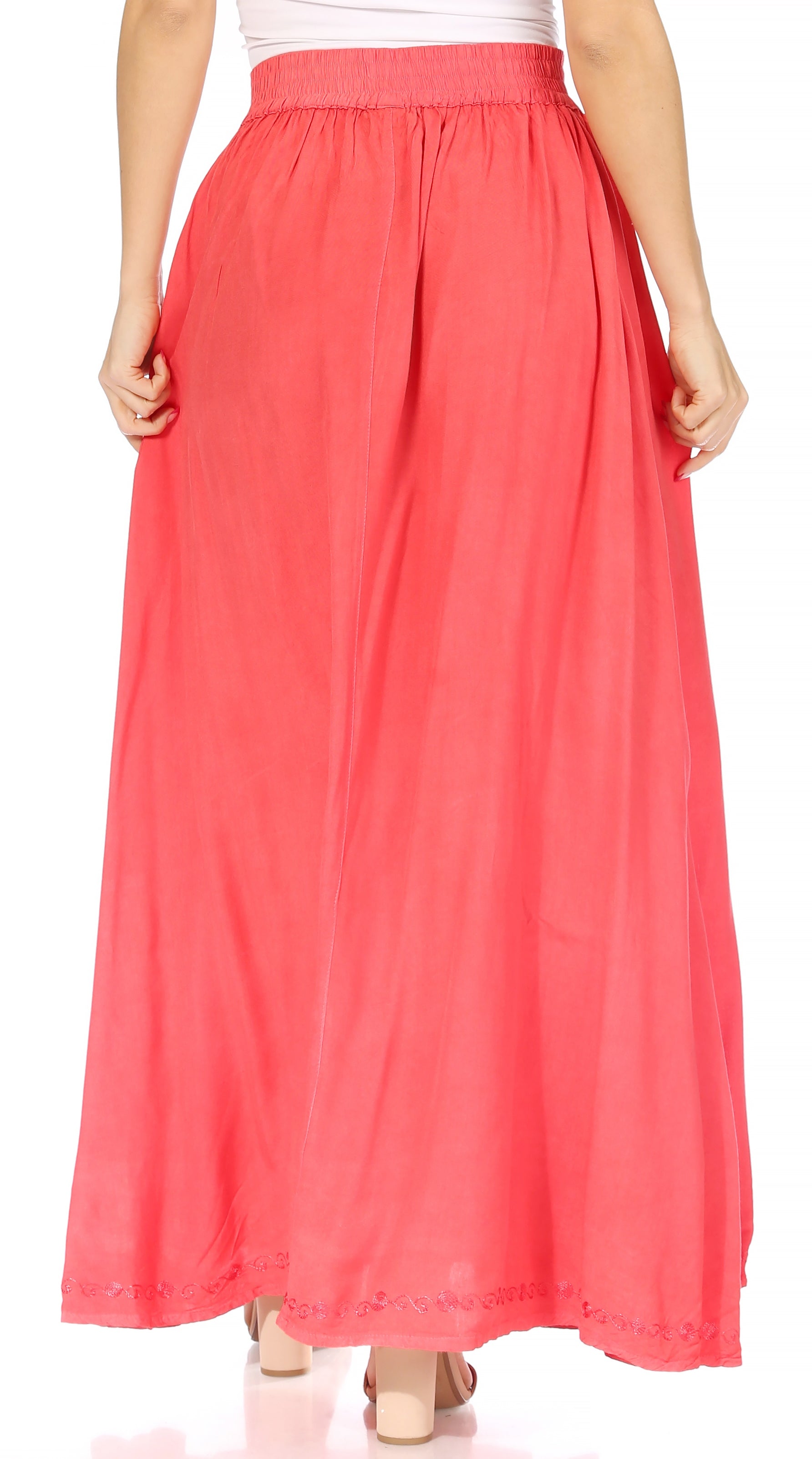 Coral pink skirt worn by a person on a white background
