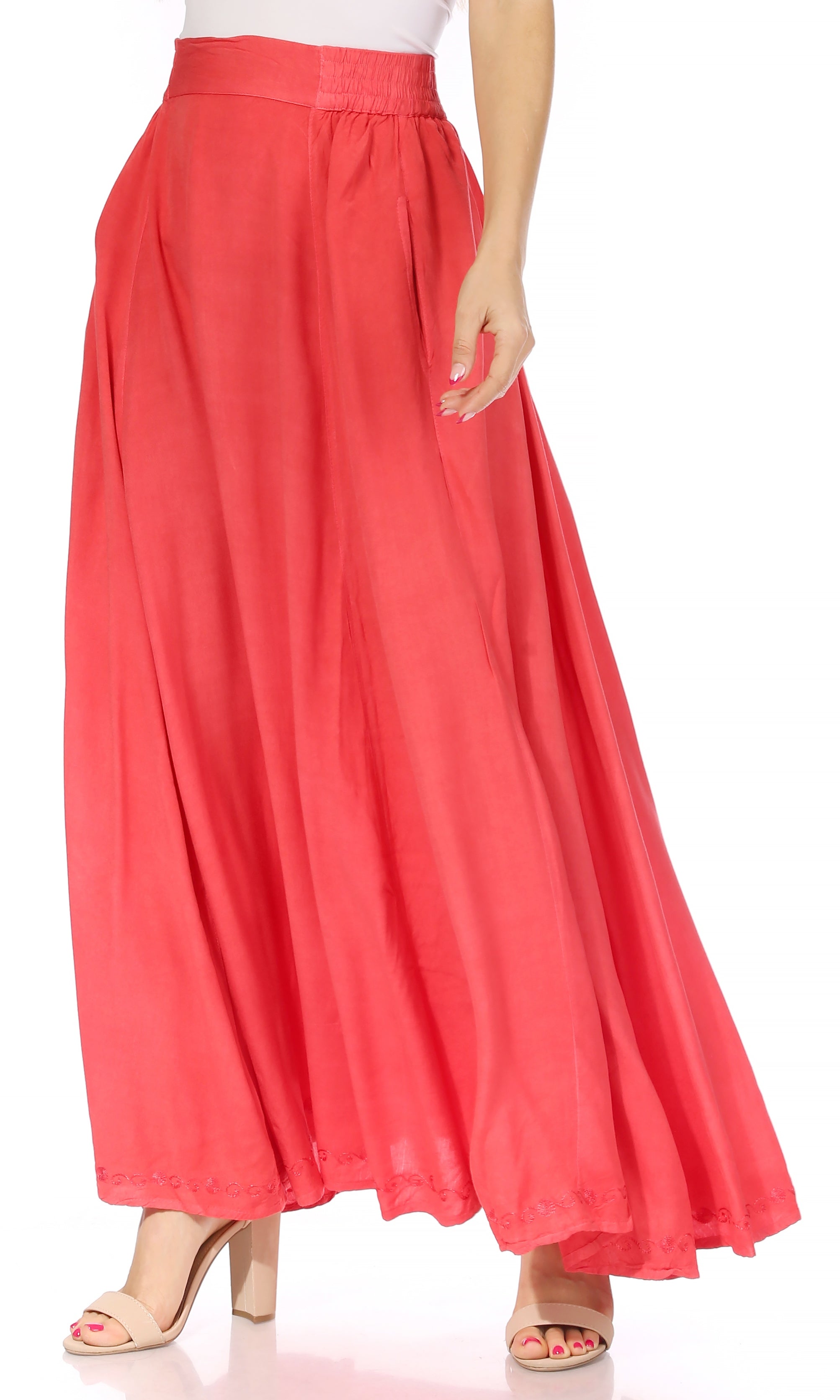 Coral pink skirt worn by a person on a white background