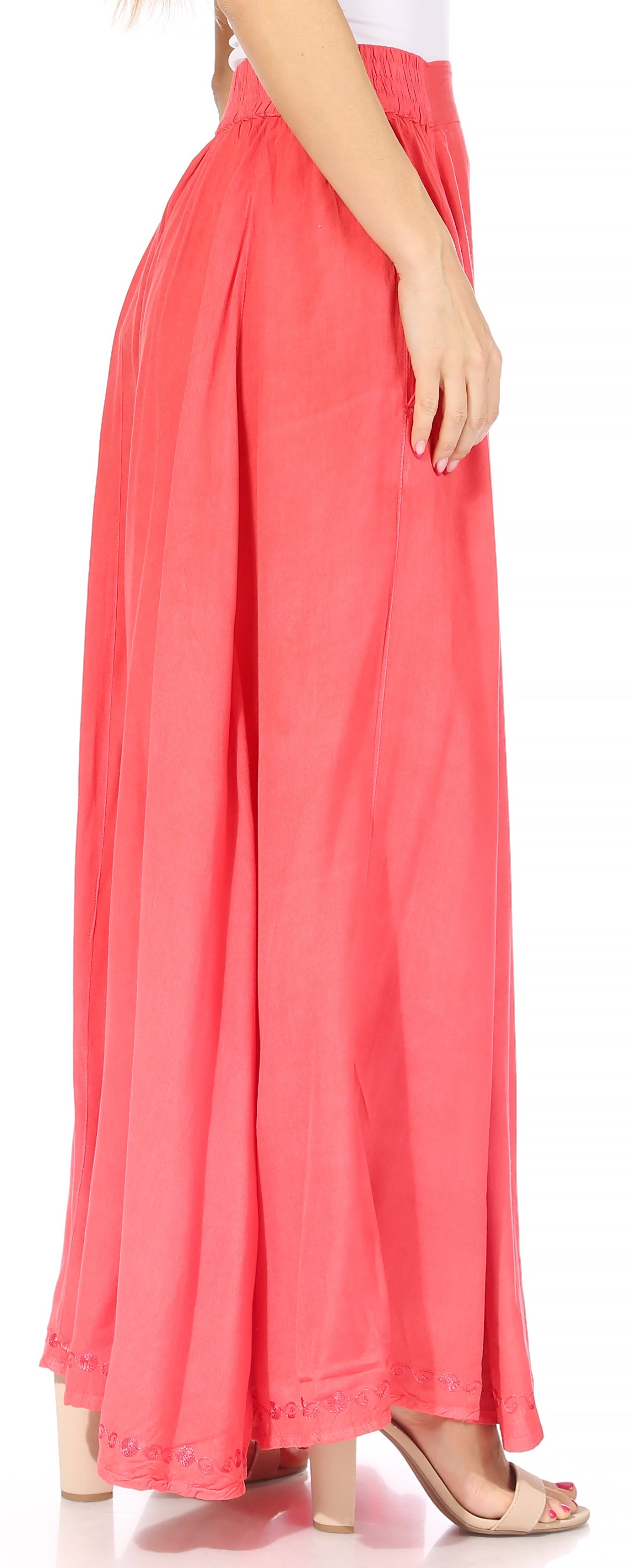 Coral-colored skirt worn by a person on a white background
