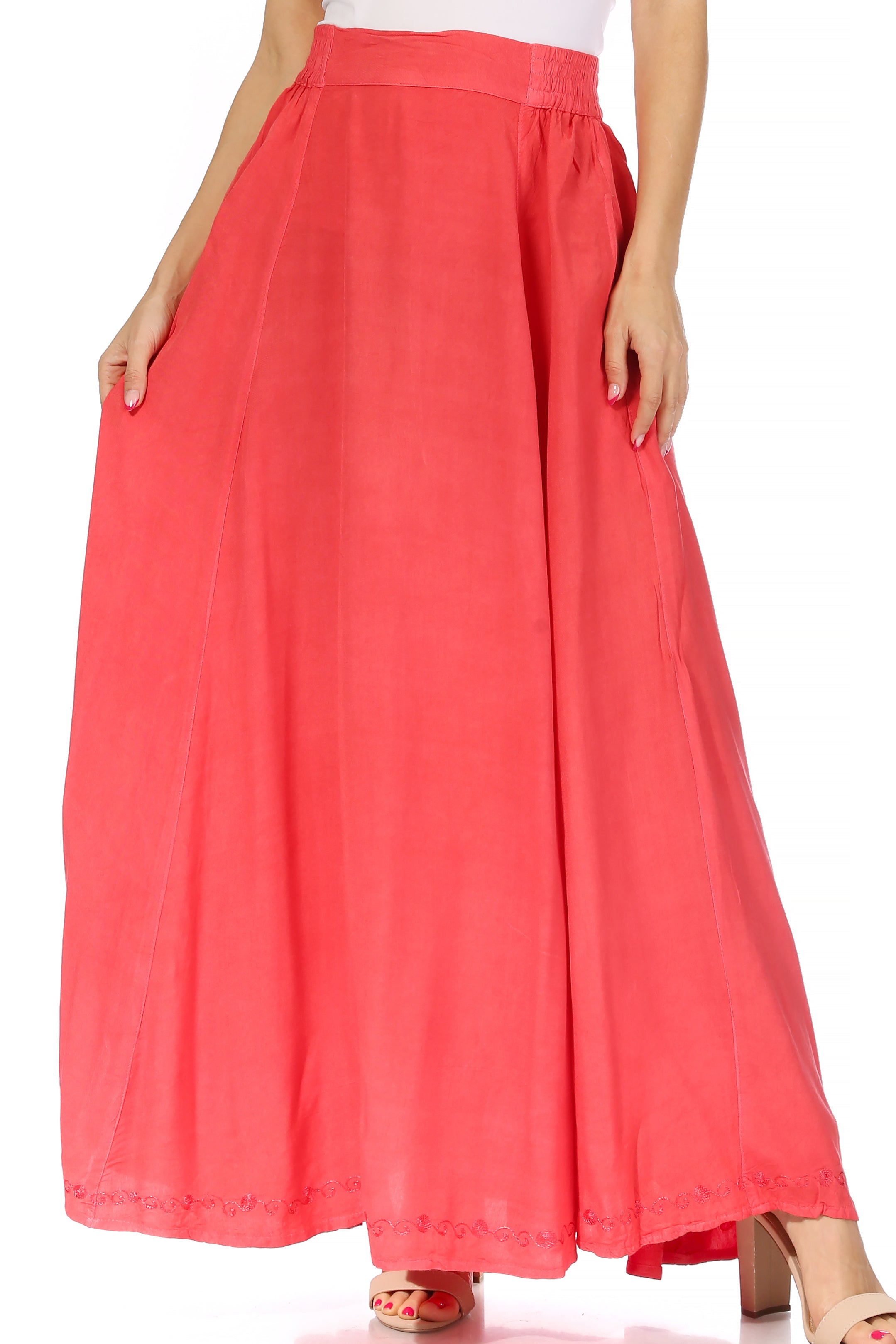 Coral pink wide-leg pants worn by a person on a white background
