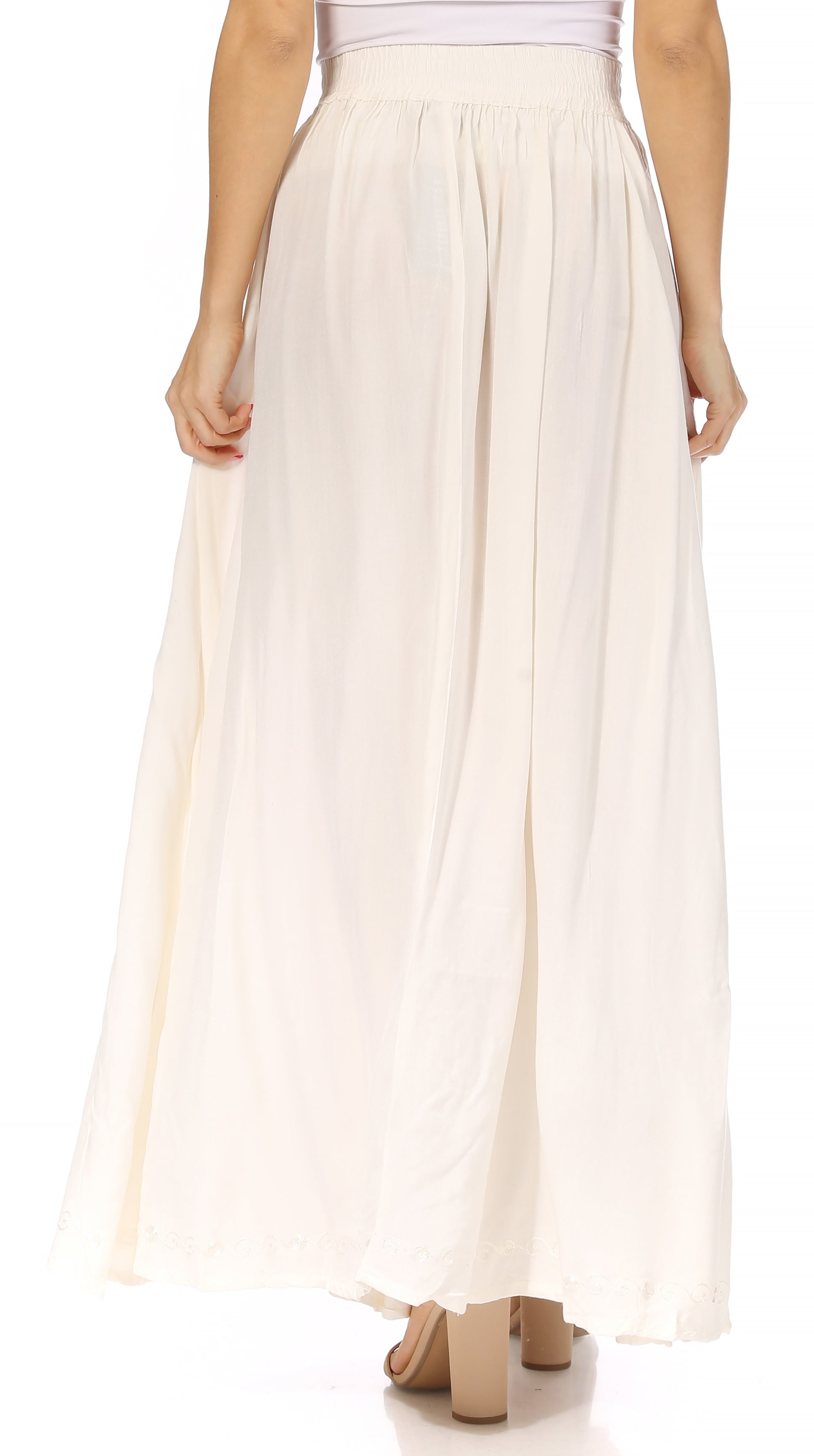 Long beige skirt worn by a person on a white background