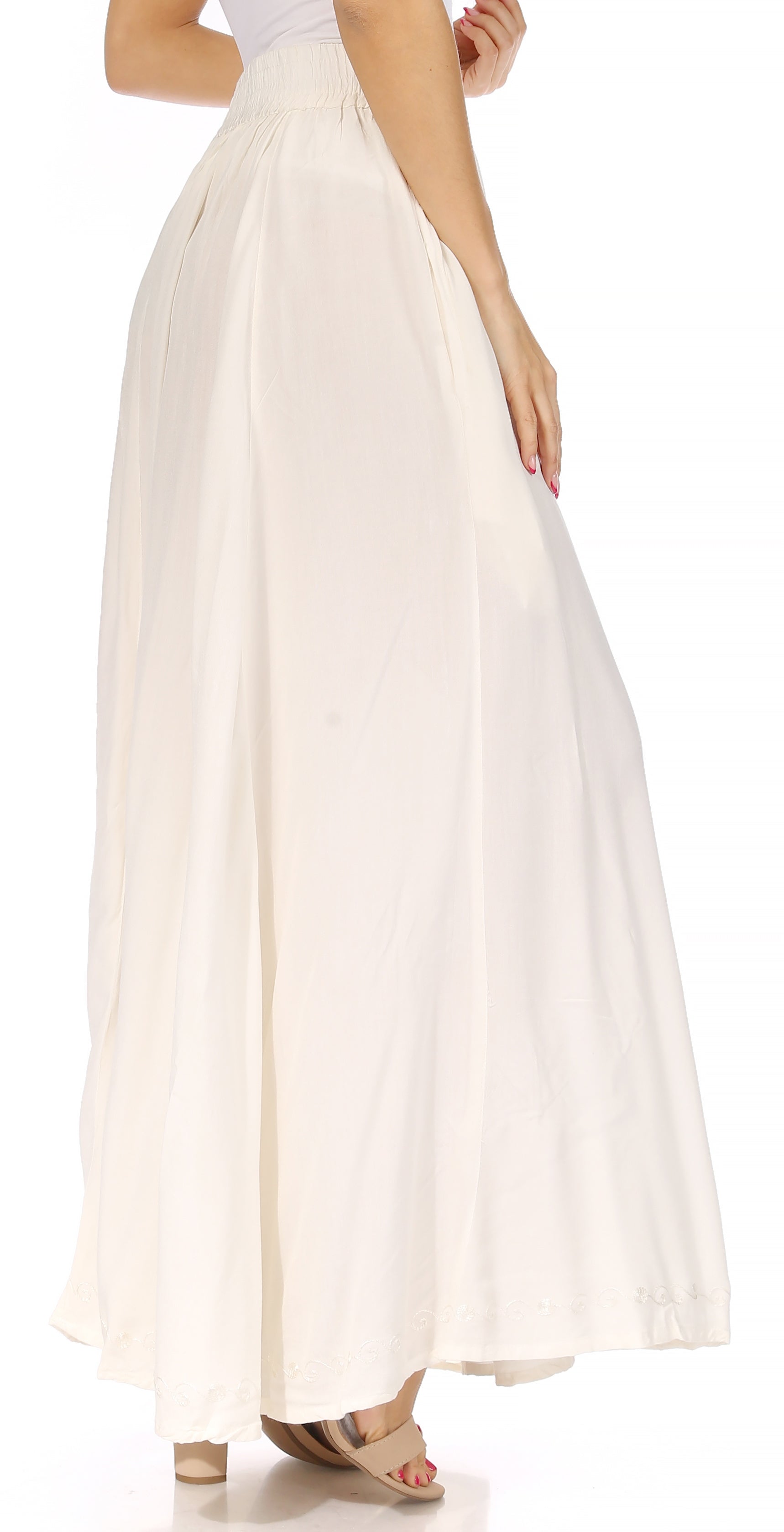 Woman wearing a long white skirt on a white background