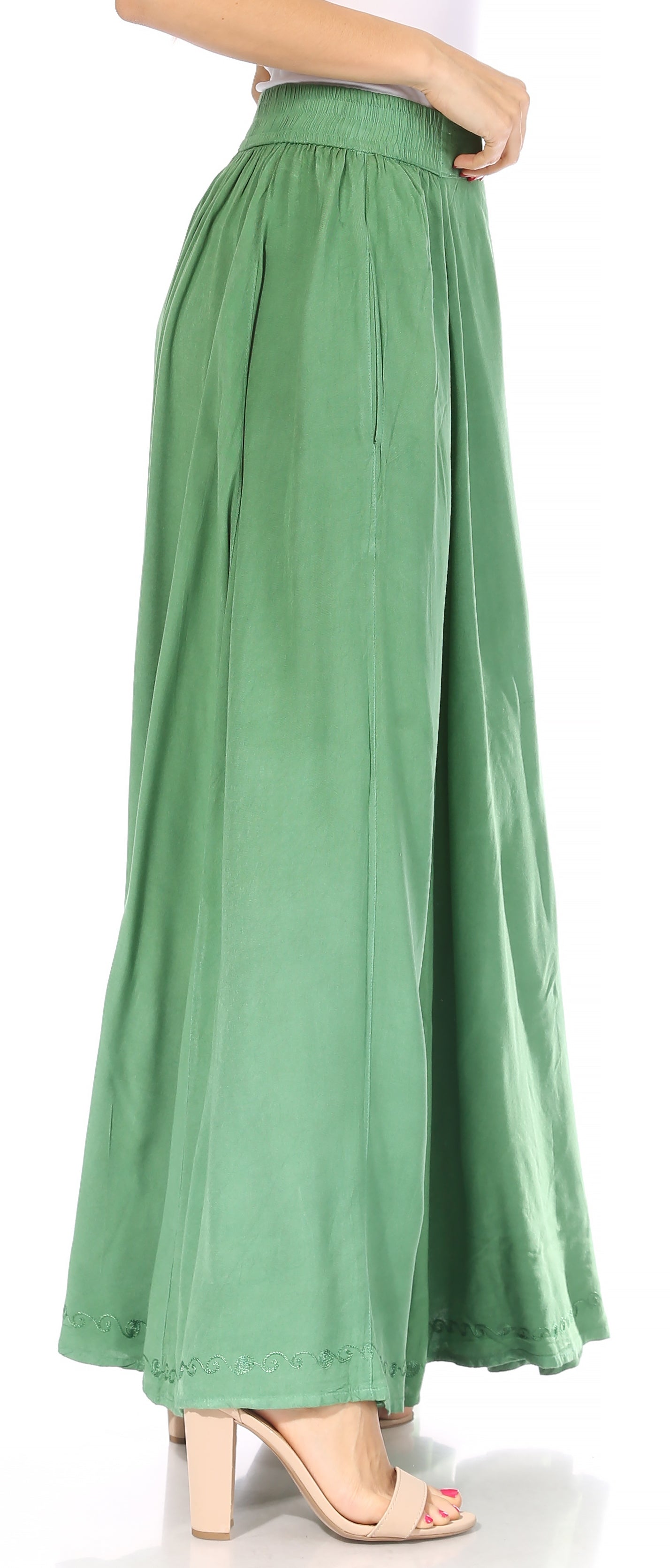 Green wide-leg pants worn by a person on a white background