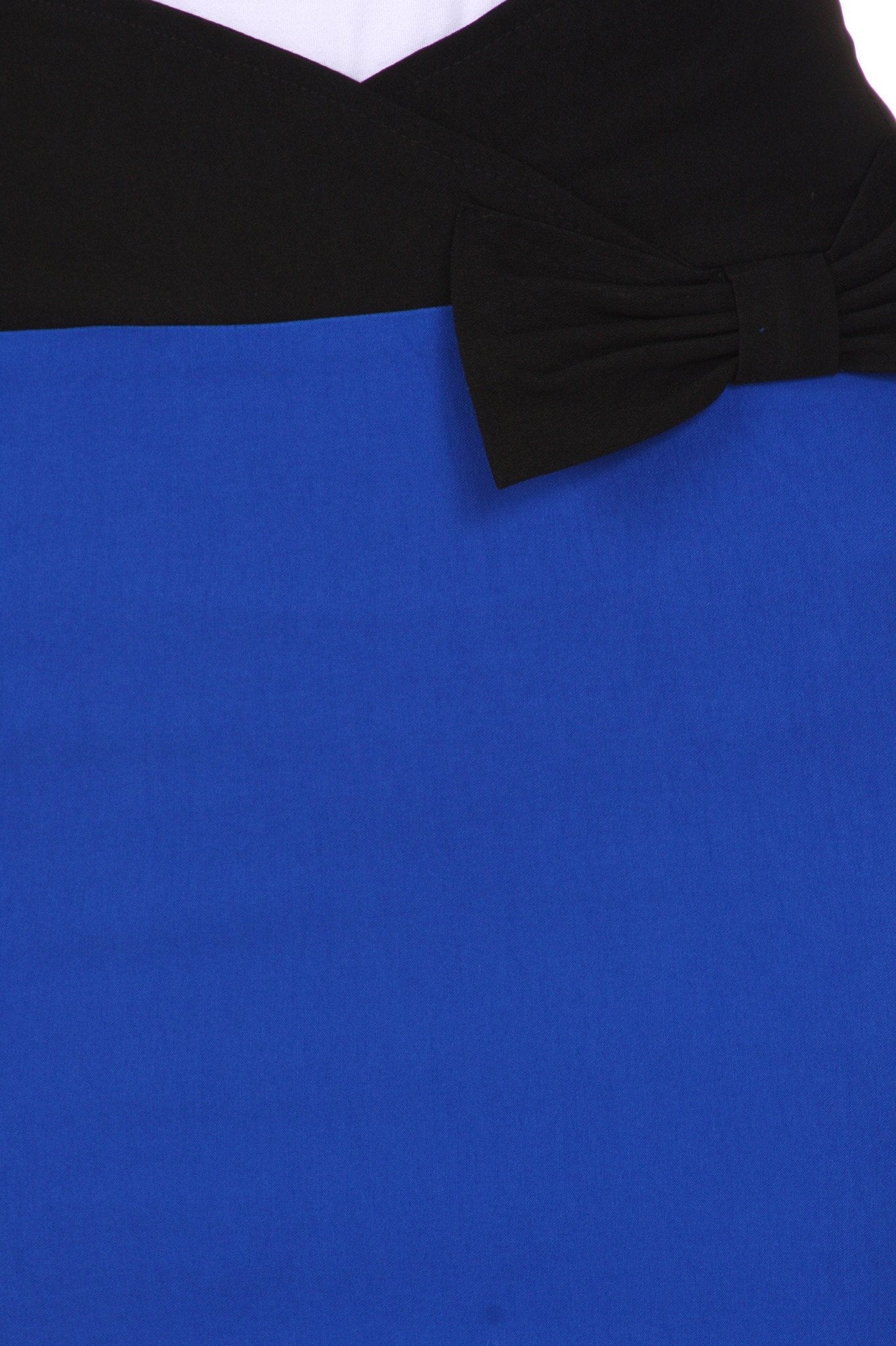 Close-up of a blue dress with a black bow detail on a white background