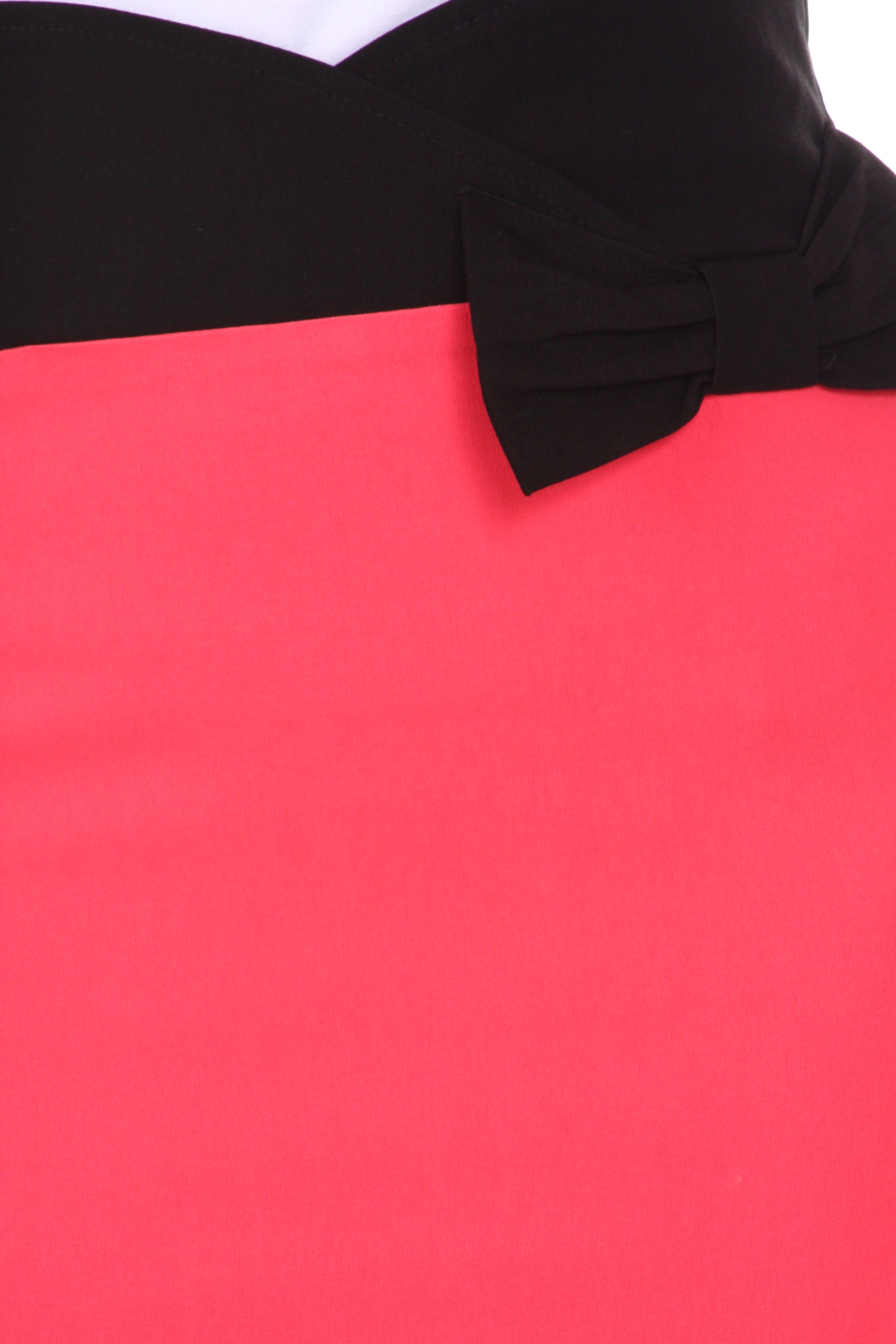 Close-up of a black bow on a red fabric background