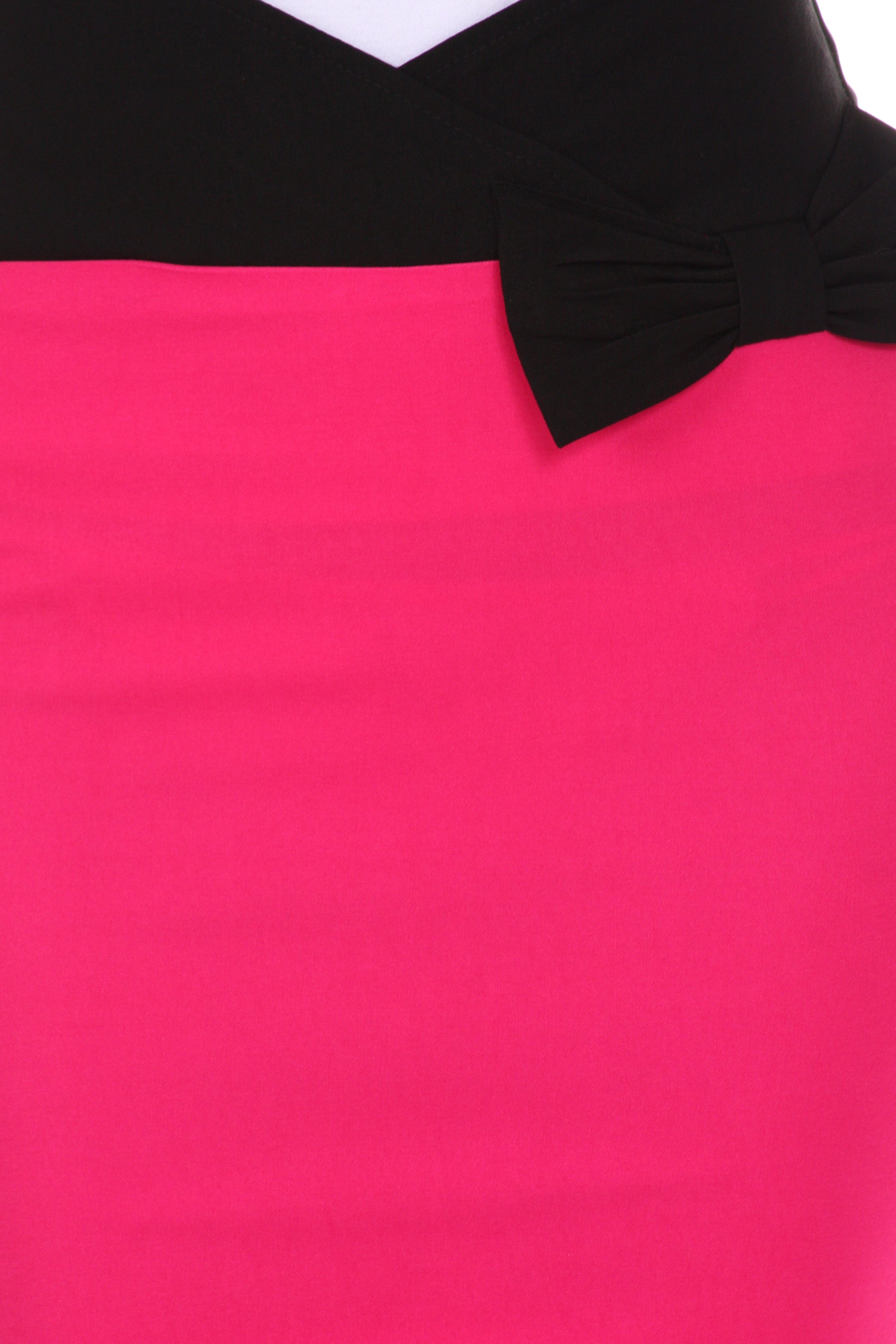 Close-up of a pink garment with a black bow detail