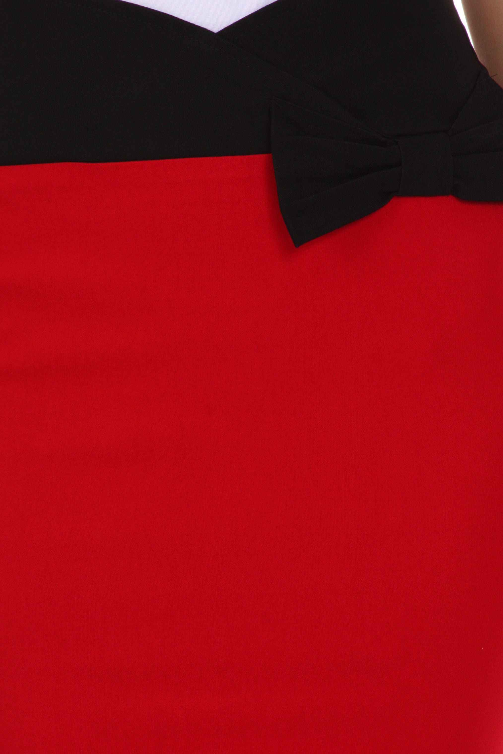 Red dress with a black bow detail on a plain background