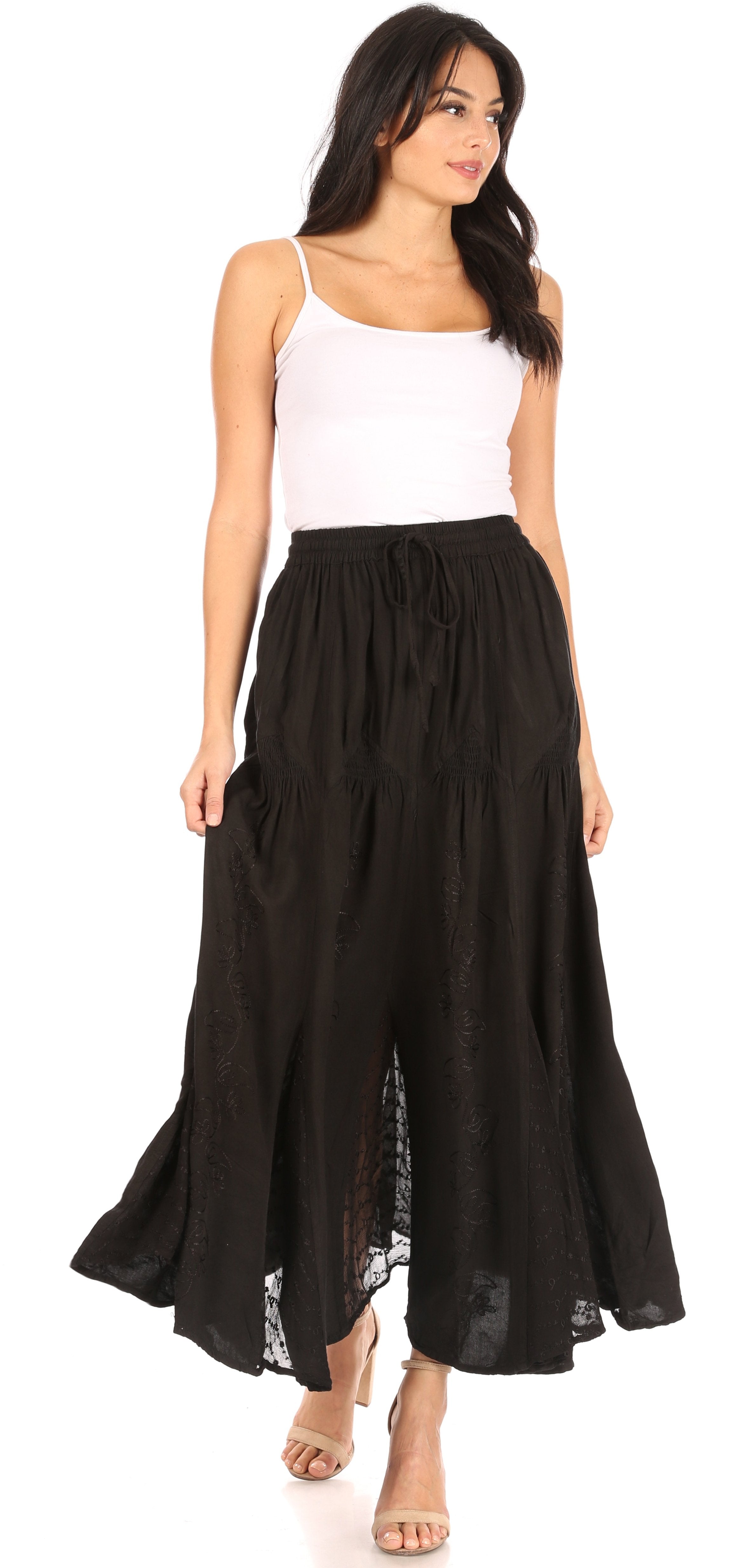 Woman wearing a white top and black long skirt on a white background