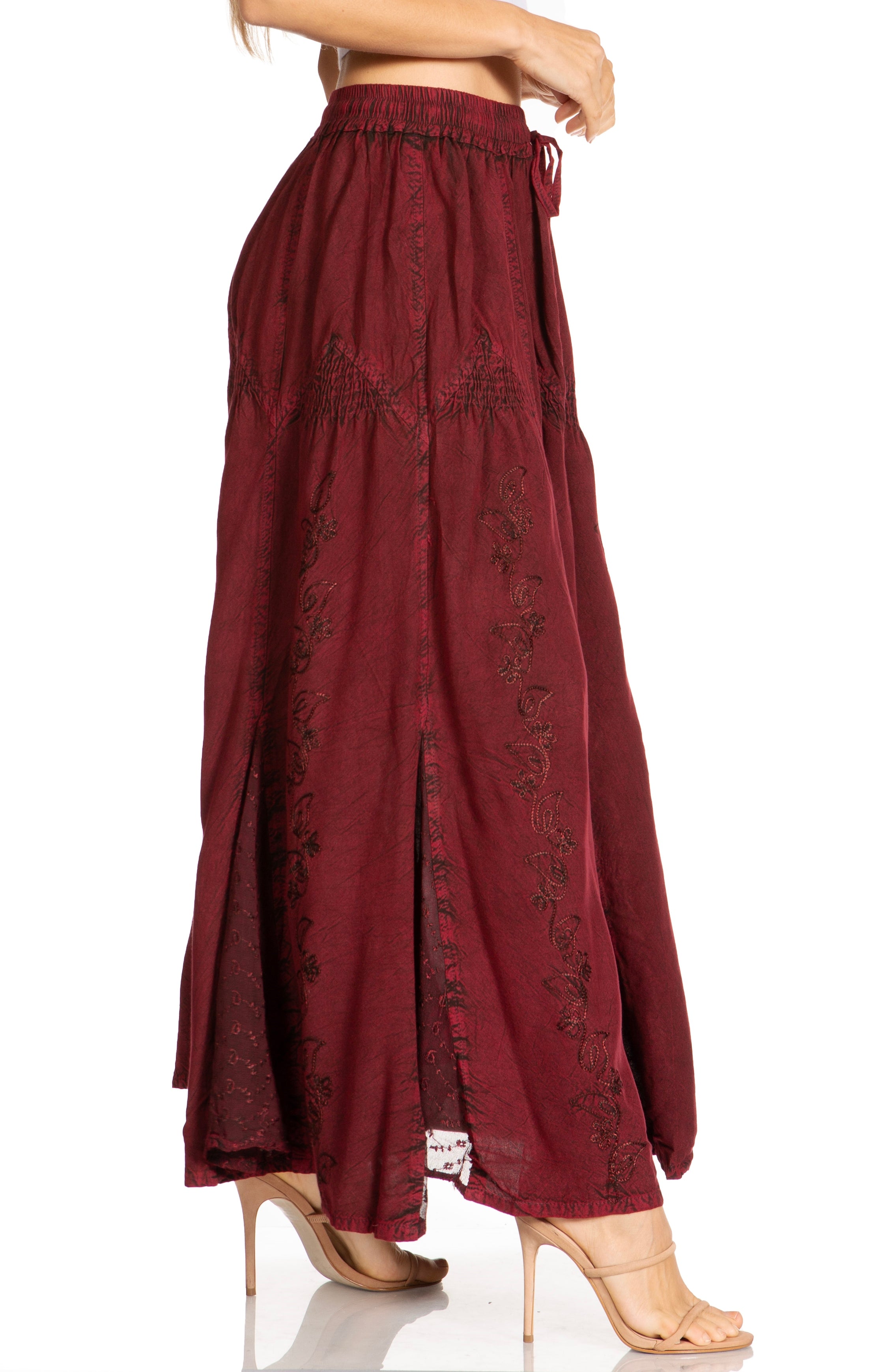Maroon pants with floral embroidery on a white background
