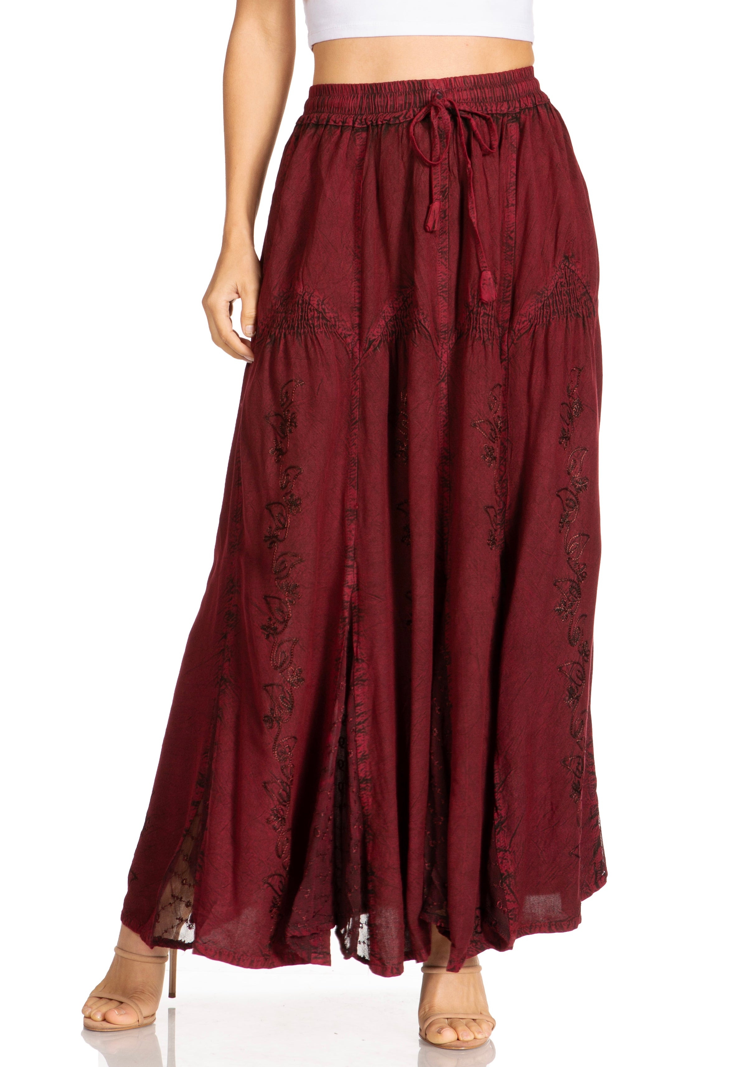 Maroon skirt with floral patterns worn by a person on a white background
