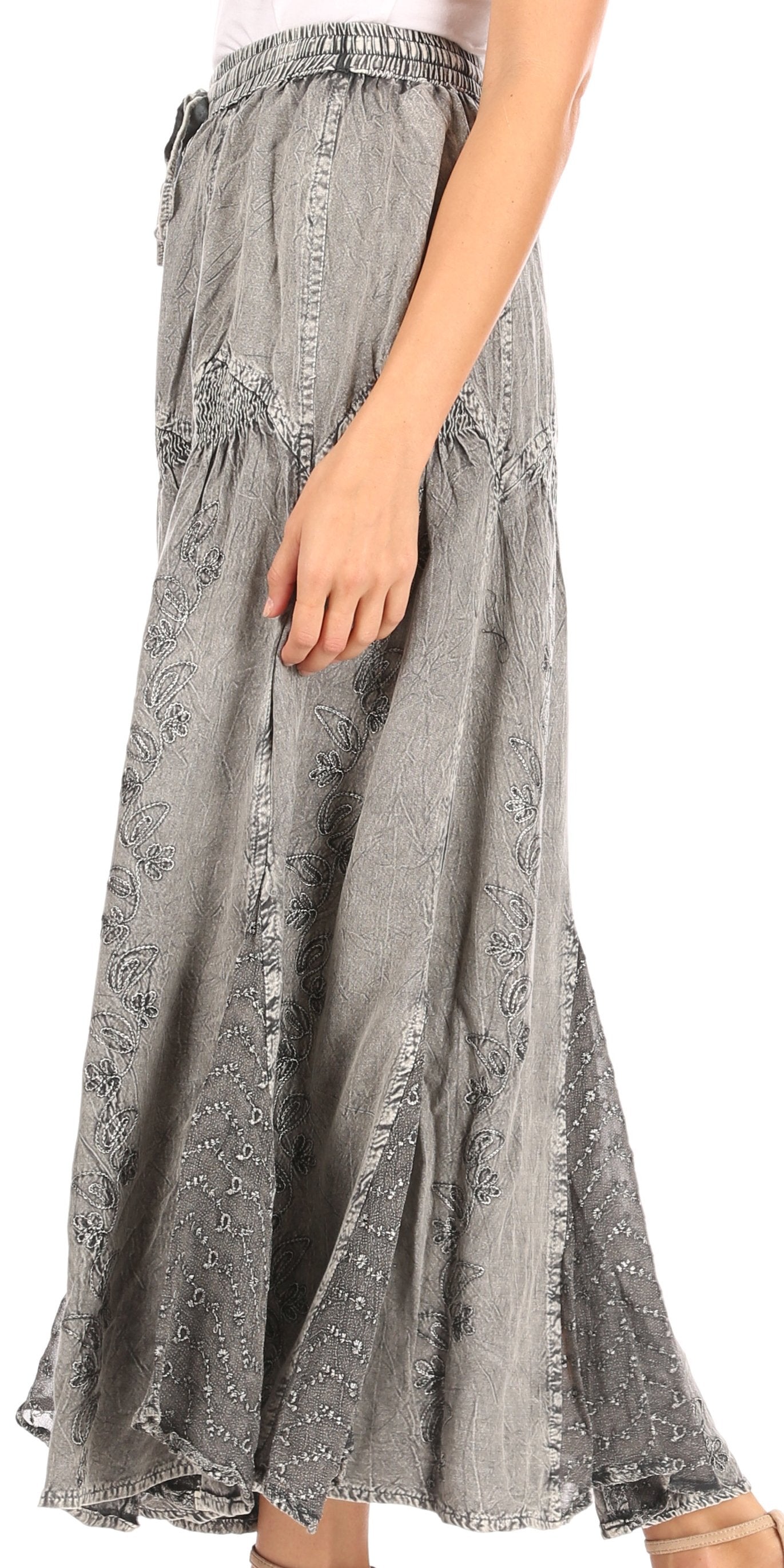 Gray patterned skirt worn by a person on a white background