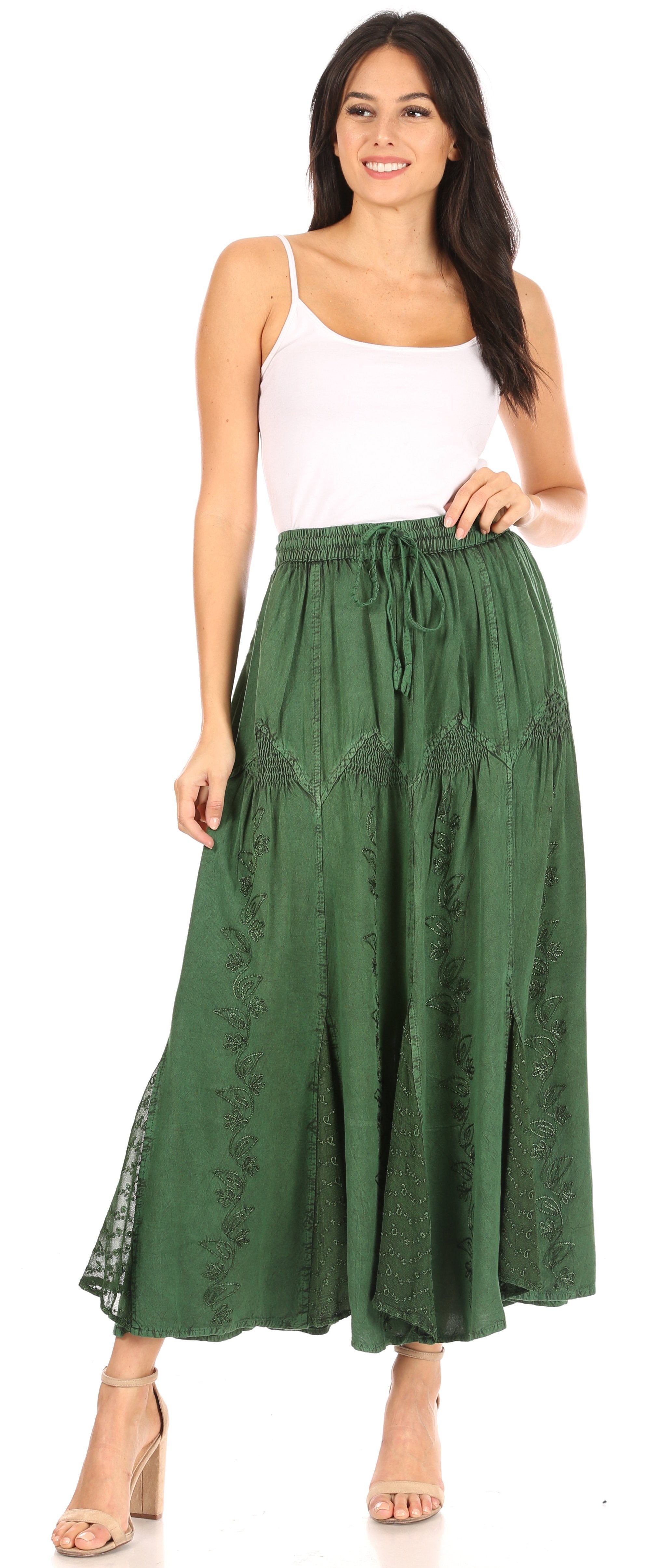 Woman wearing a white top and green skirt on a white background