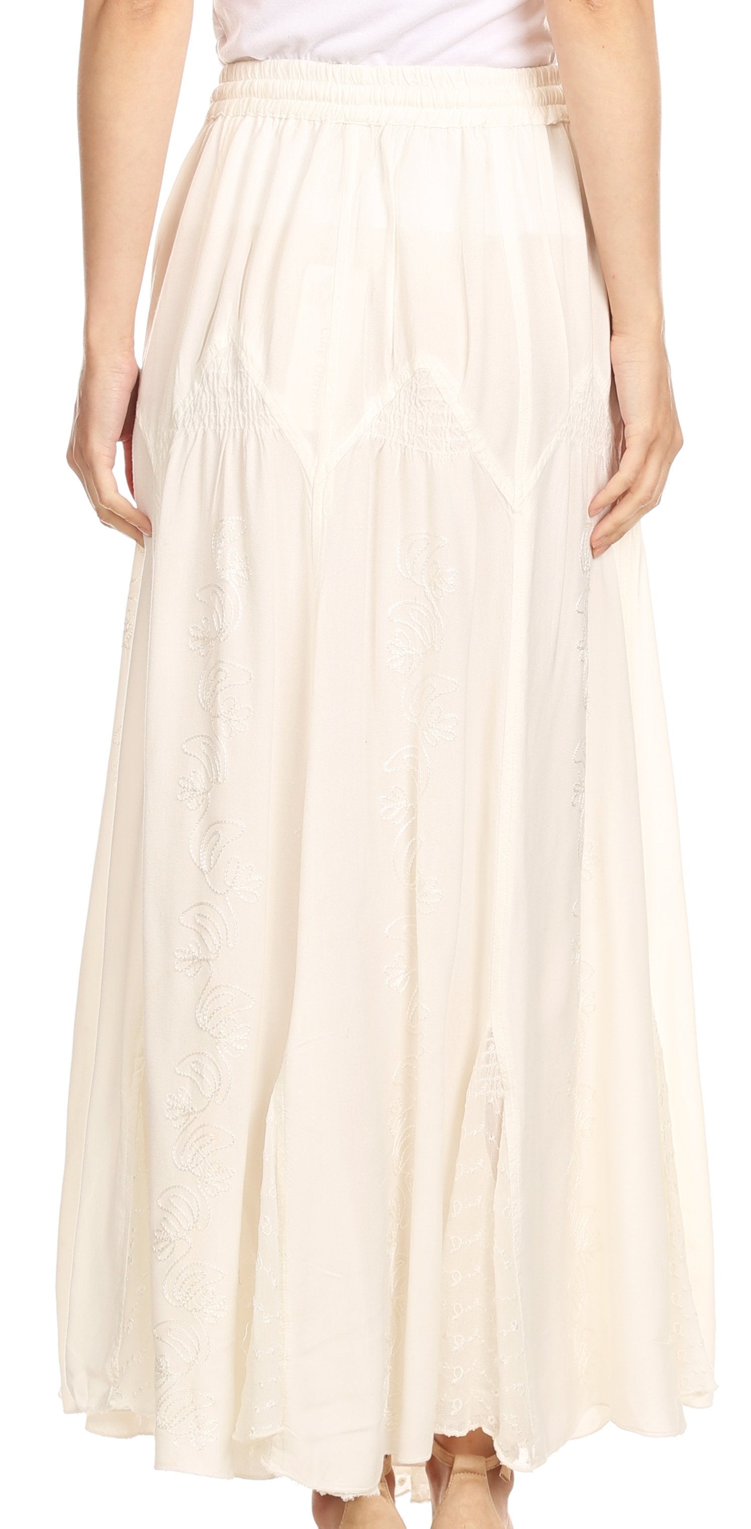 Long beige skirt worn by a person on a white background
