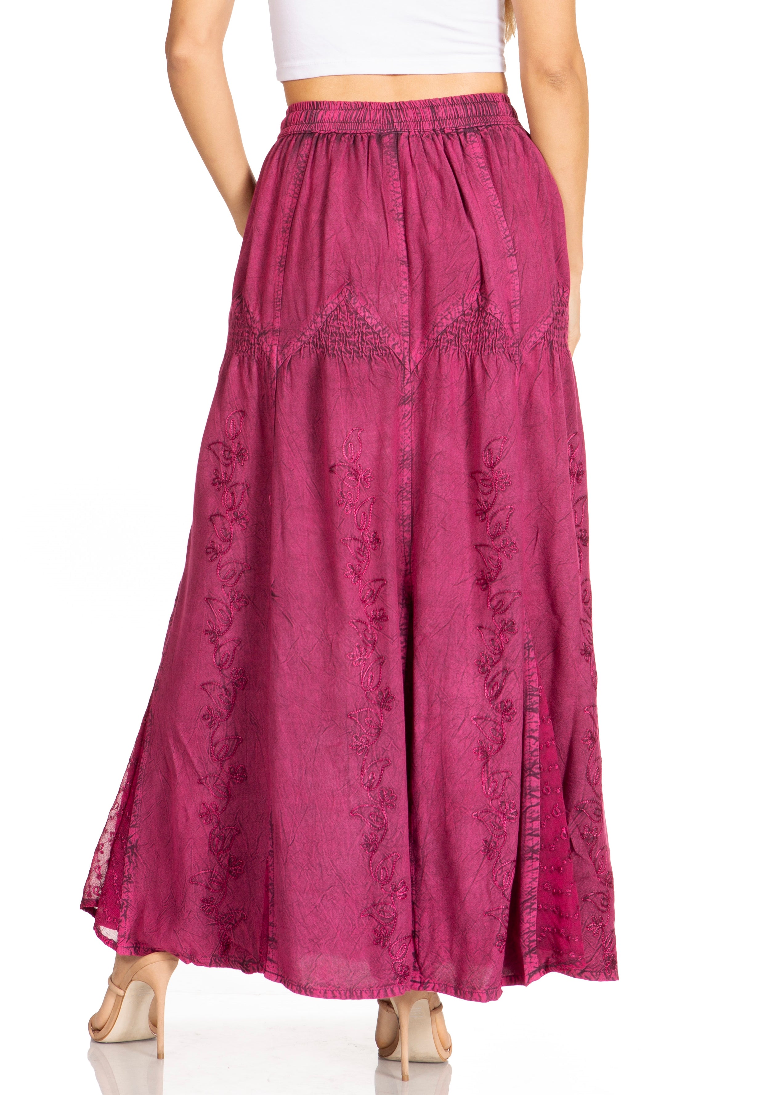 Pink embroidered skirt worn by a person on a white background
