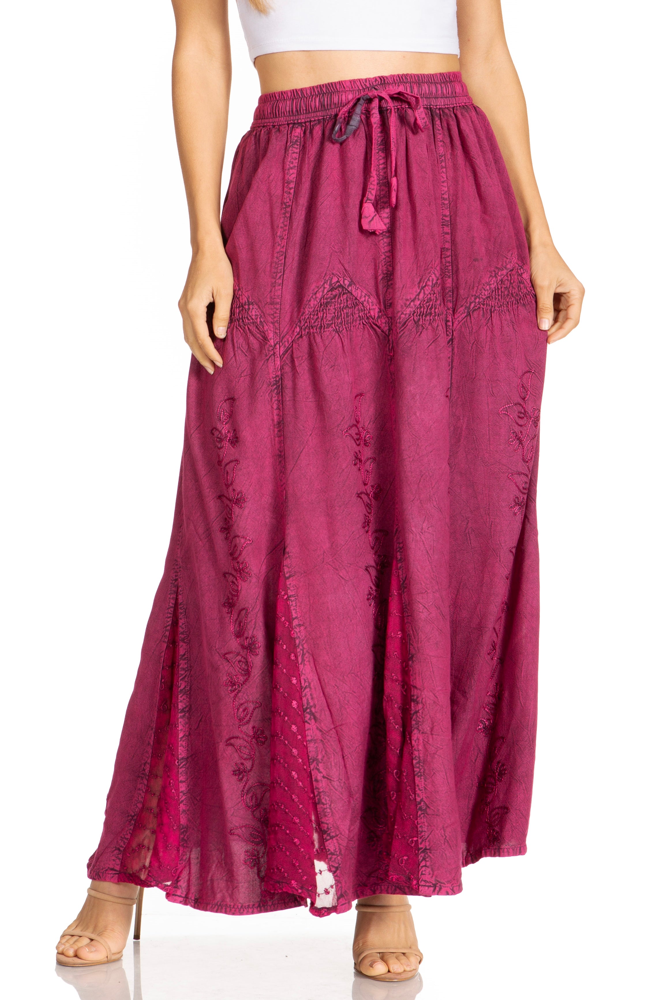 Long magenta skirt worn by a person on a white background