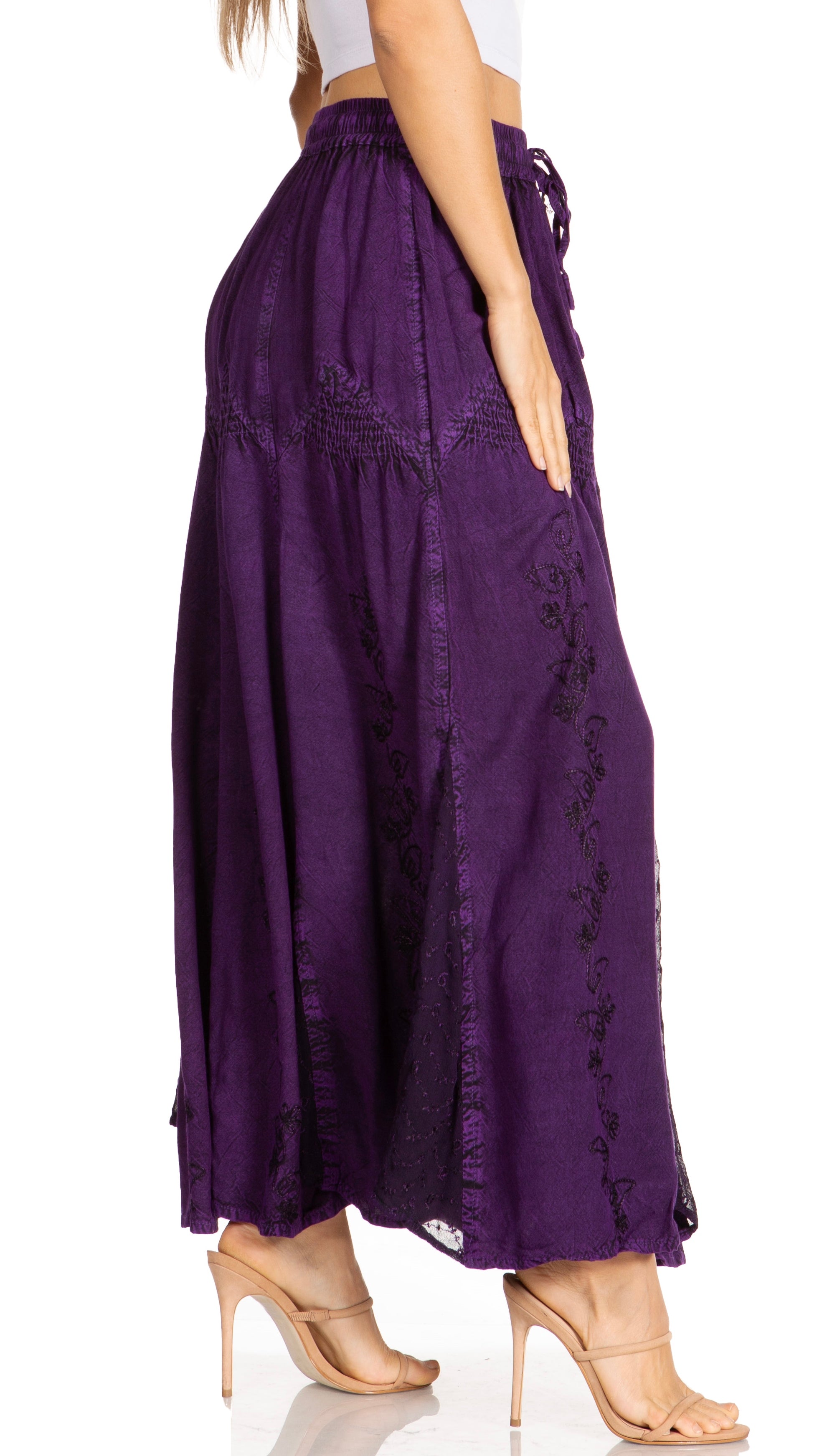 Purple skirt with lace details worn by a person on a white background