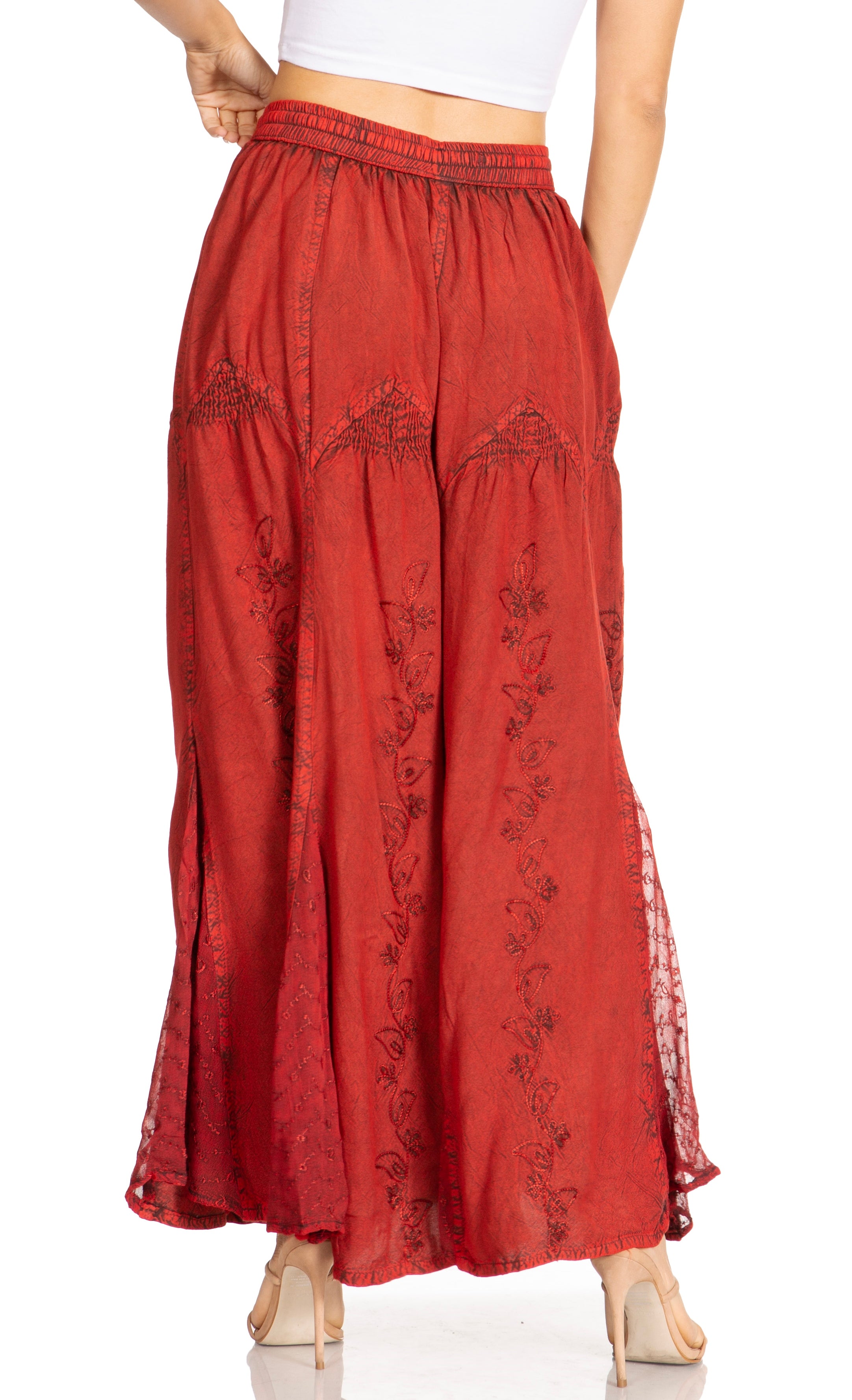 Red embroidered pants on a white background