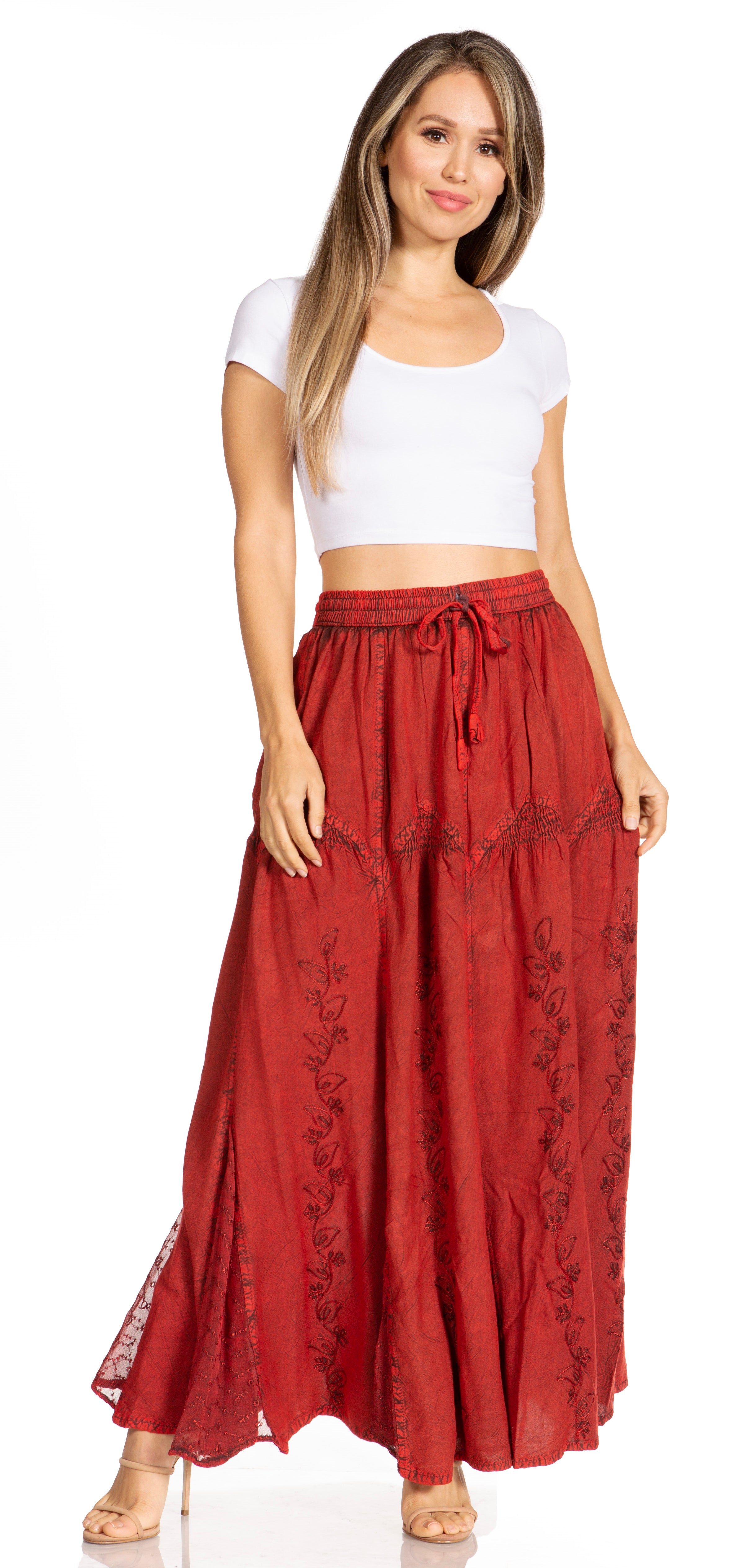 Woman wearing a white top and red skirt with lace details on a white background