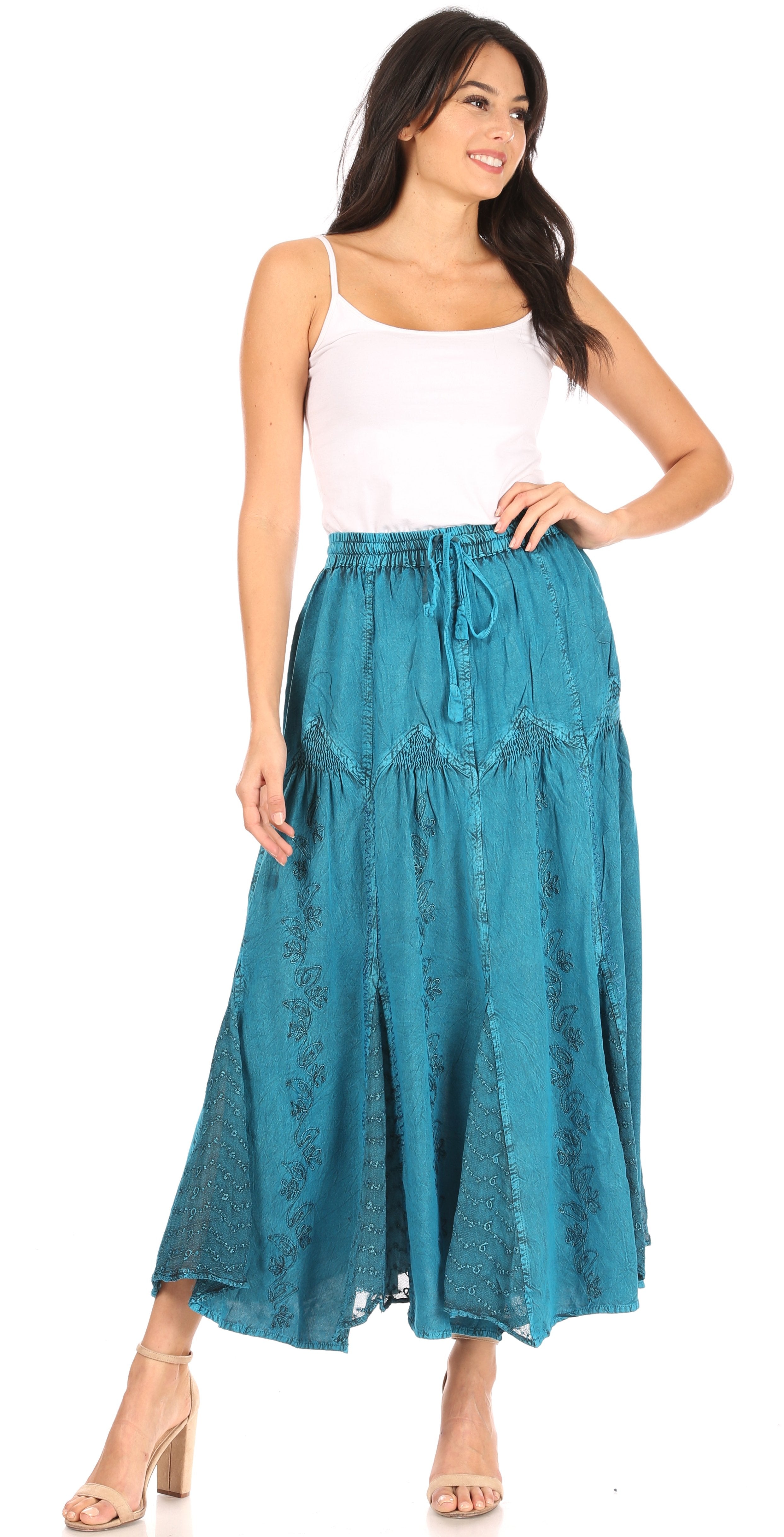 Woman wearing a teal skirt with a white top on a white background