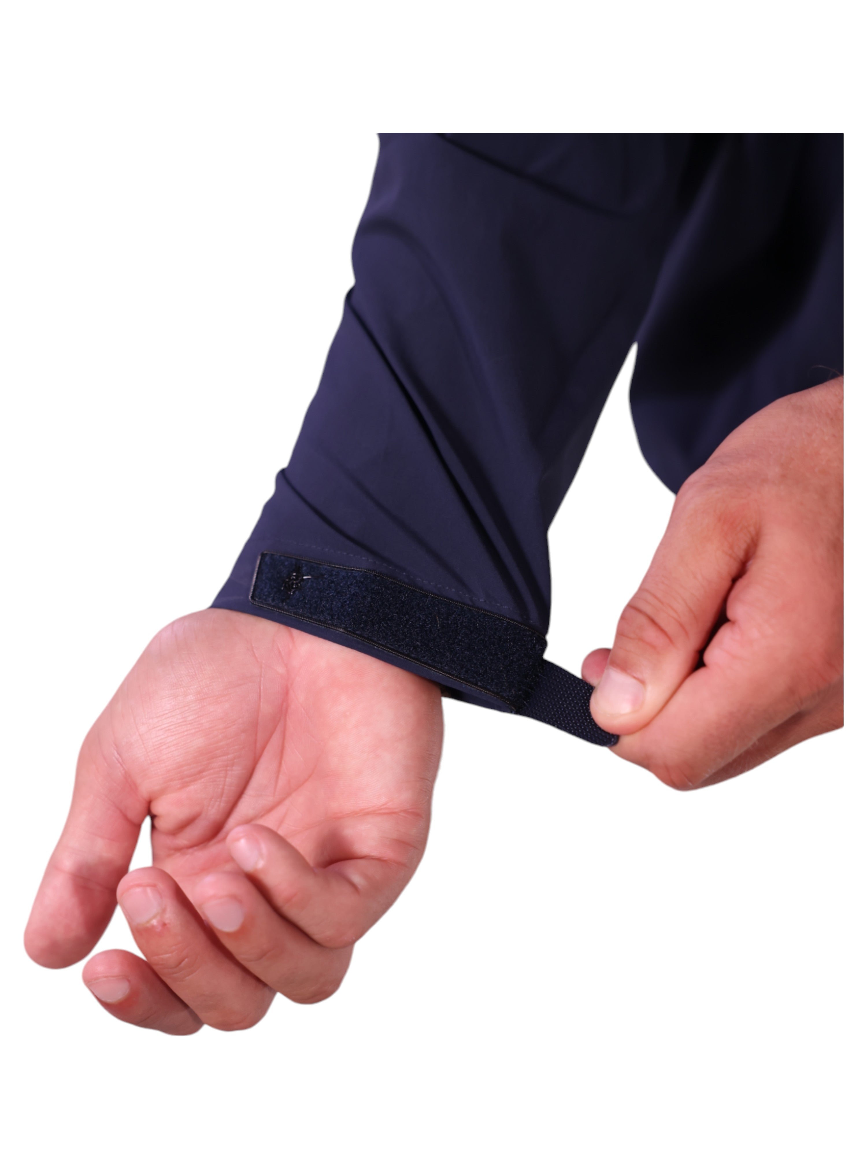 Person adjusting a navy blue sleeve with a black elastic band on a white background