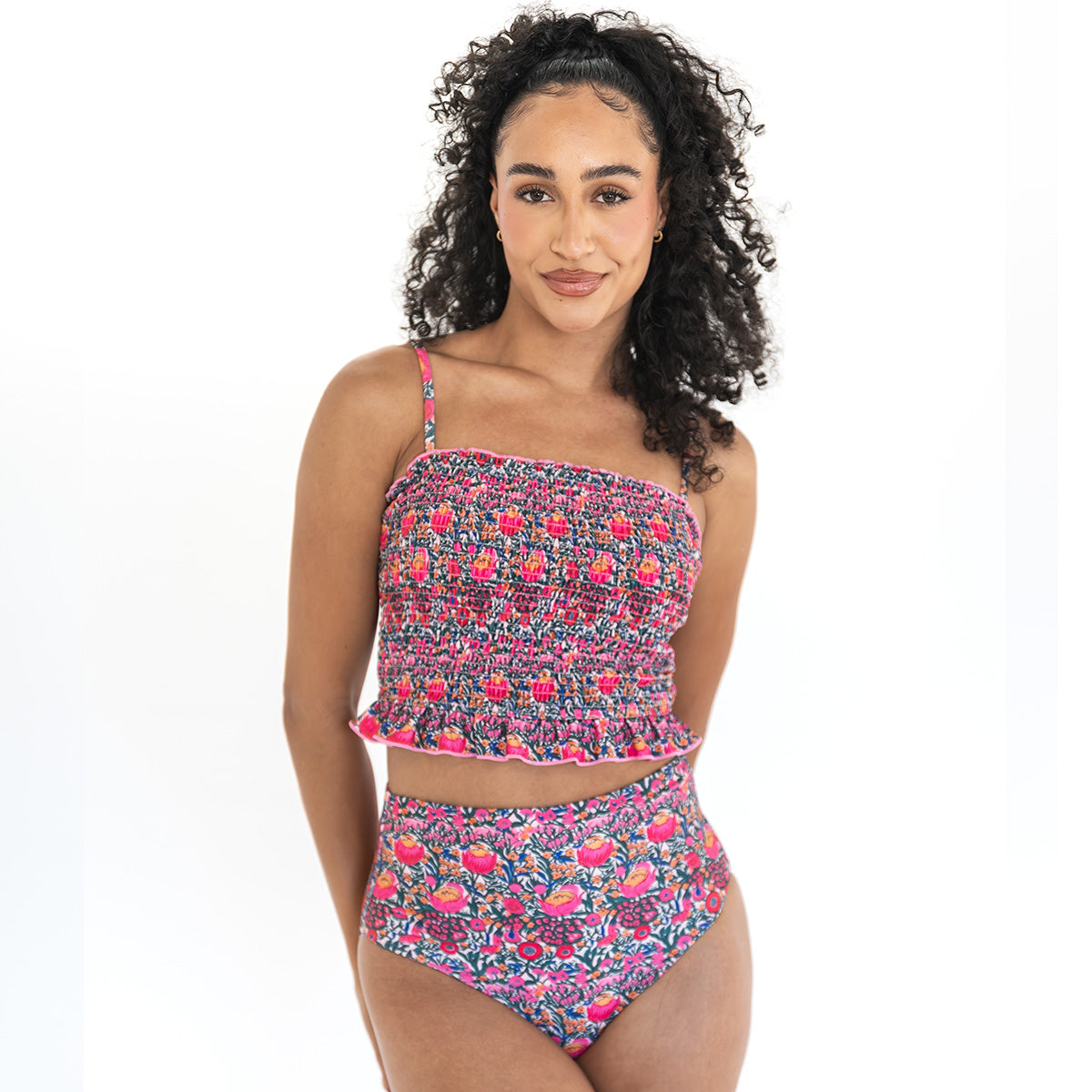 Woman wearing a floral two-piece swimsuit on a white background