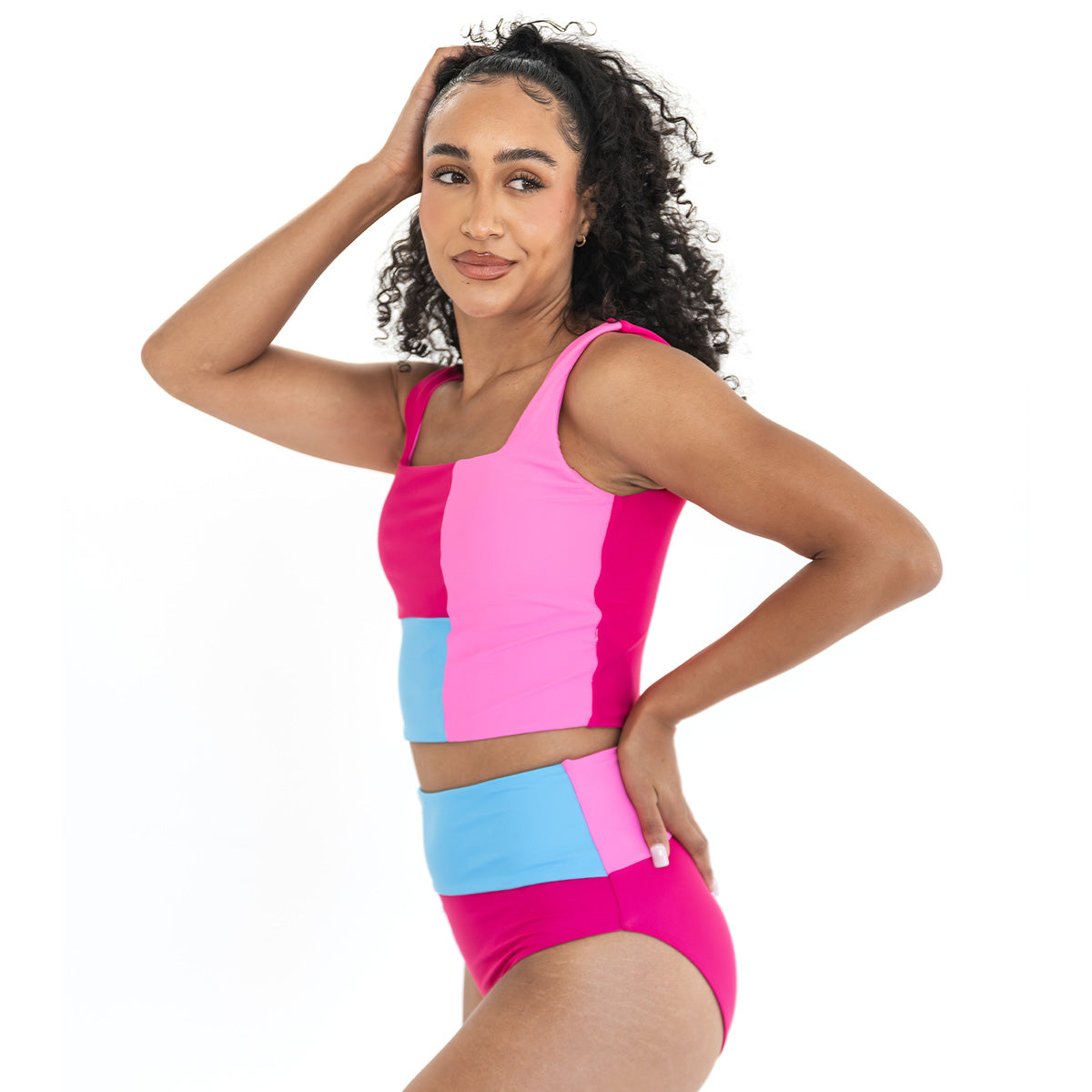Woman wearing a colorful two-piece swimsuit on a white background