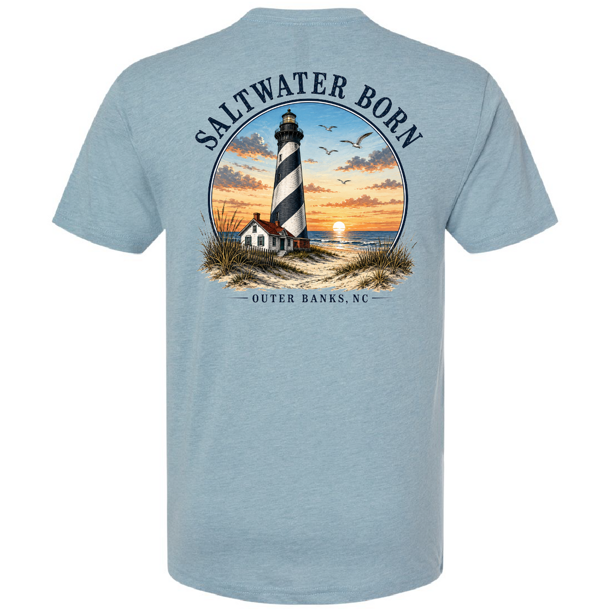 A light blue heather crewneck t-shirt shown from the back, featuring a large graphic print of a lighthouse on a beach at sunset with the text 'SALTWATER BORN' and 'OUTER BANKS, NC'.
