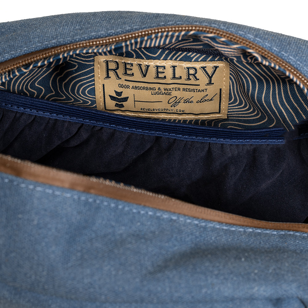 Close-up of a blue denim product with a 'Revelry' label inside.