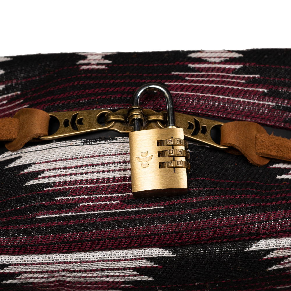 Brass padlock on a woven fabric background