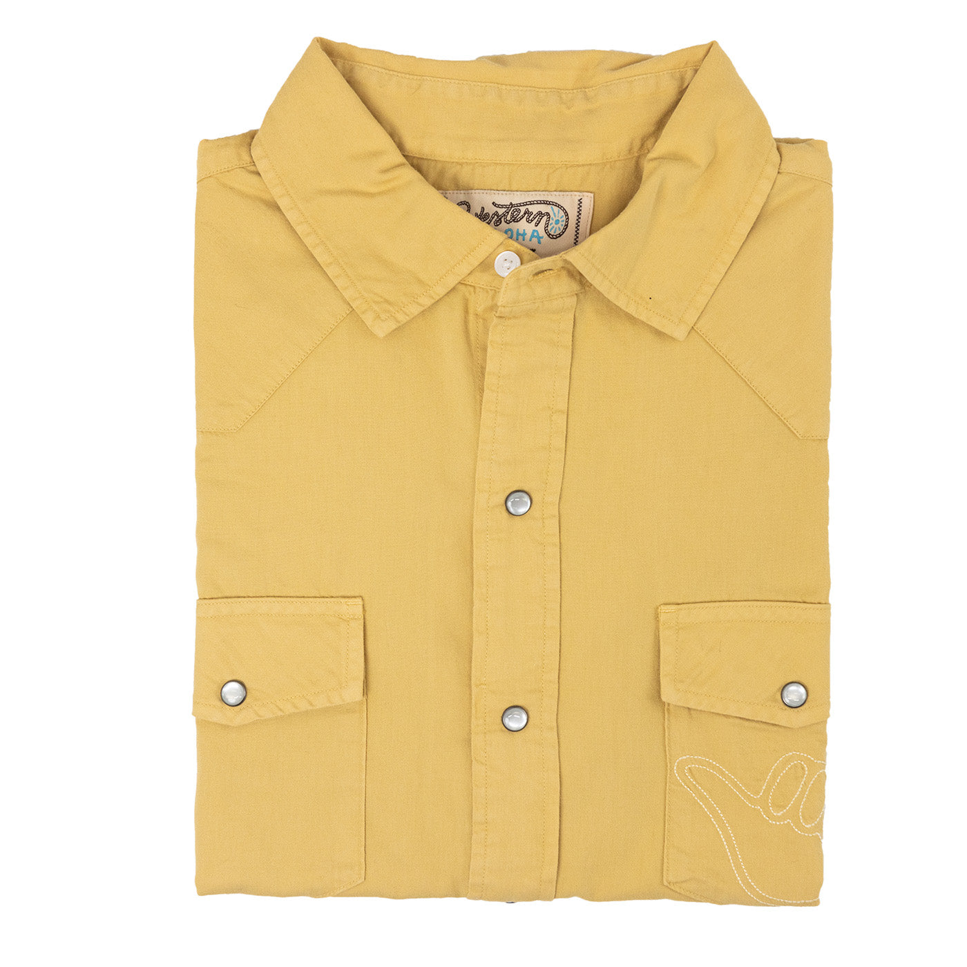 Folded mustard yellow shirt with brand label on a white background