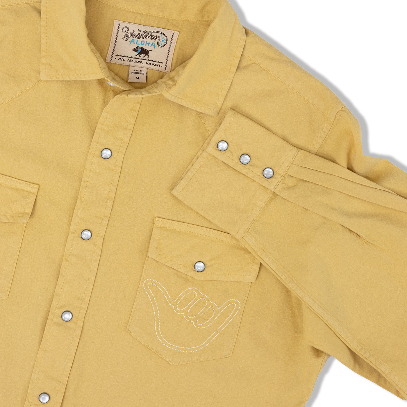 Yellow shirt with a 'Western Aloha' label on a white background